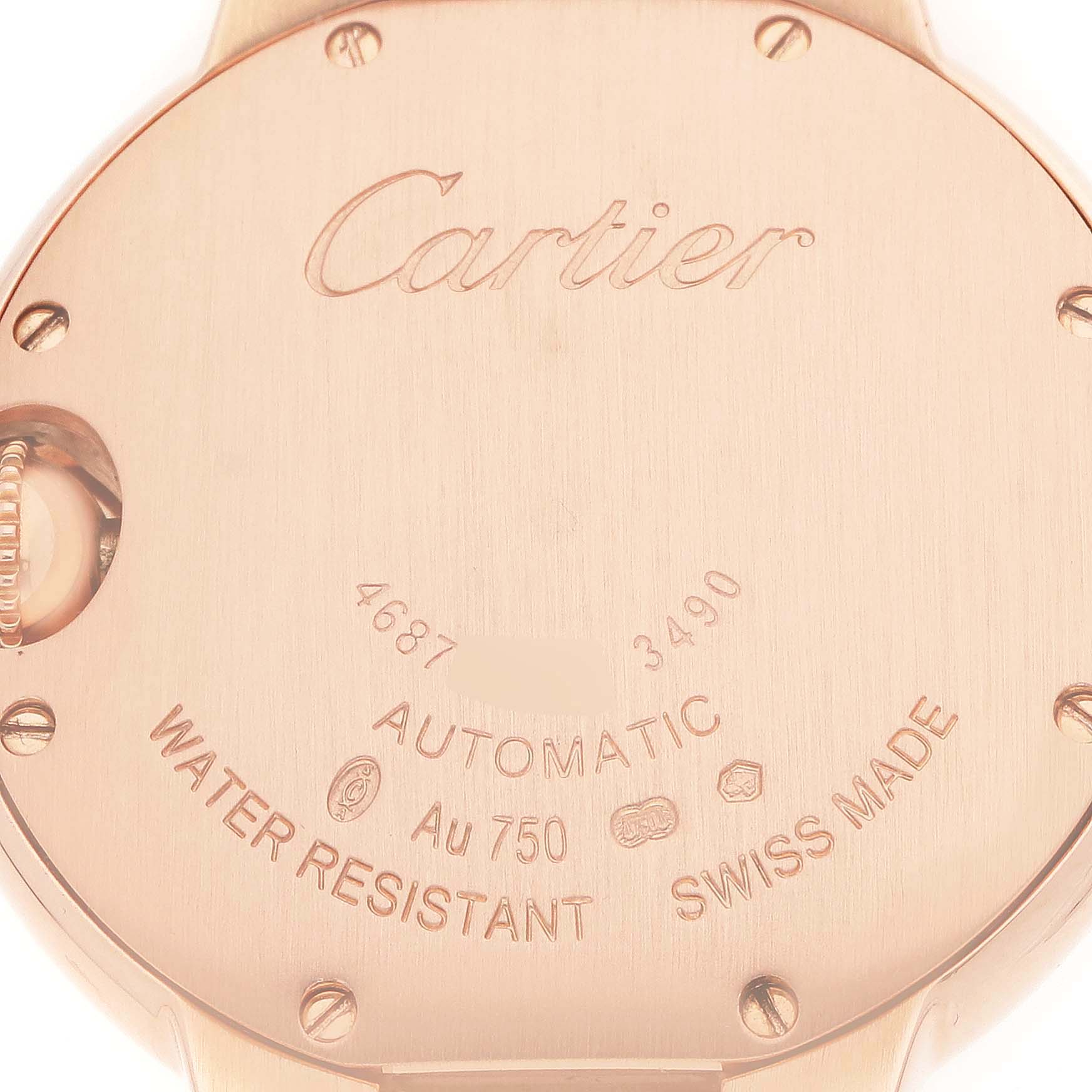 The image shows the back of a Ballon Bleu de Cartier watch, displaying inscriptions and screw details.