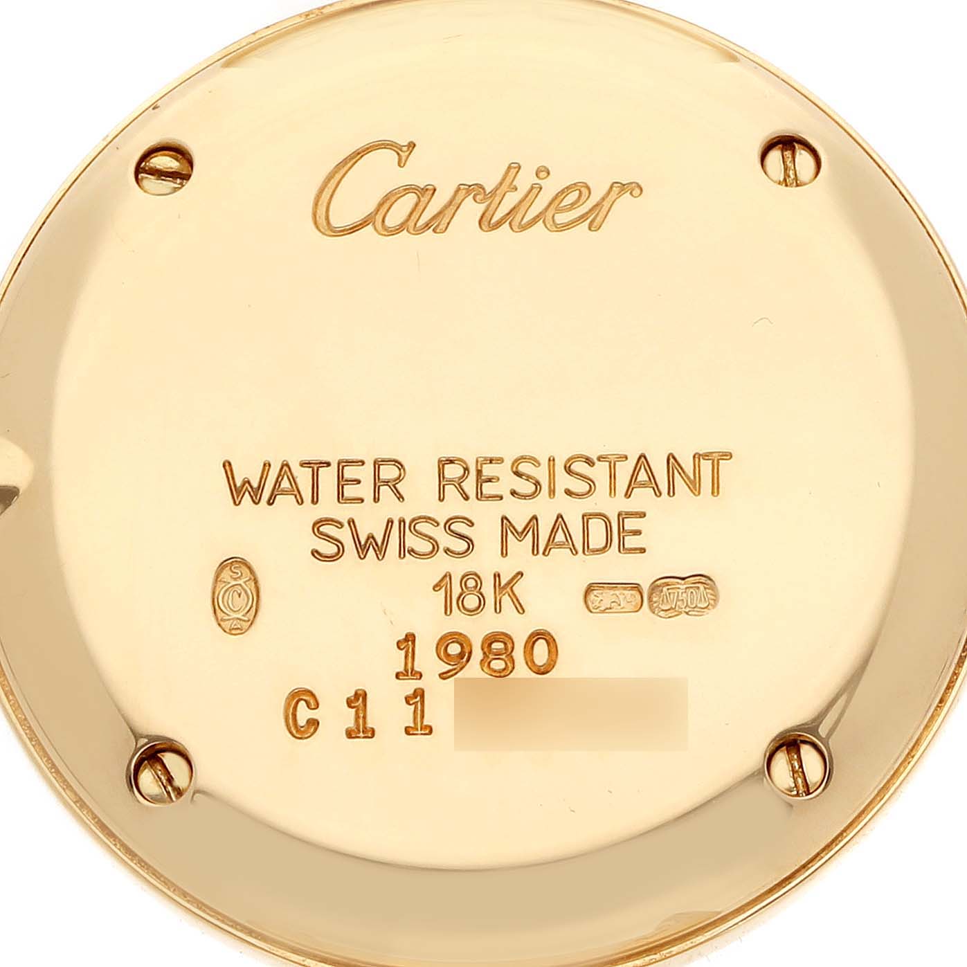 The image shows the back of a Cartier Colisee WB1018A8 Women
s Yellow Gold Silver Dial watch, highlighting the engravings and screw details.