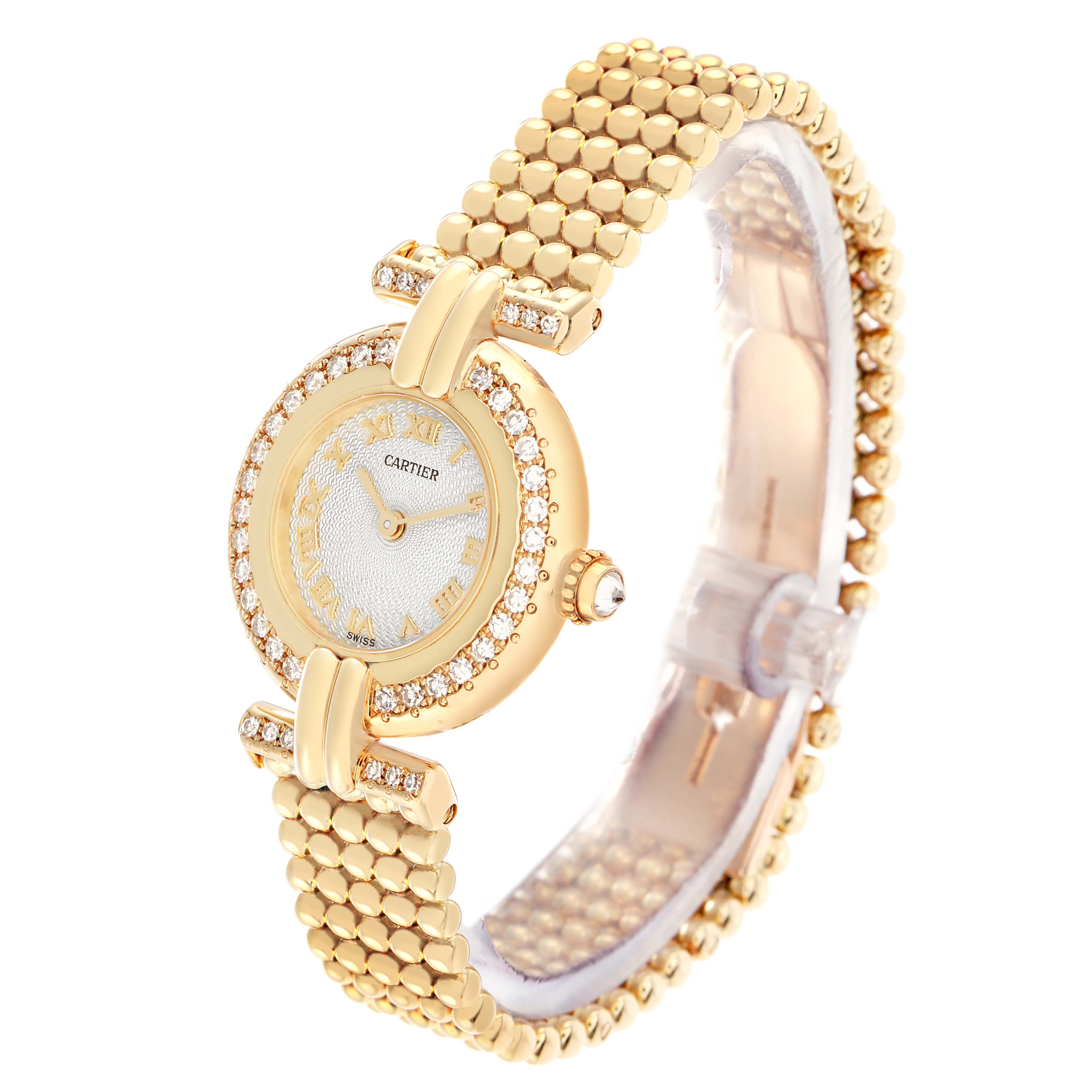 The Cartier Colisee WB1018A8 Women
s Yellow Gold Silver Dial watch is shown at a slight side angle, displaying the round face, beaded bracelet, and diamond accents.