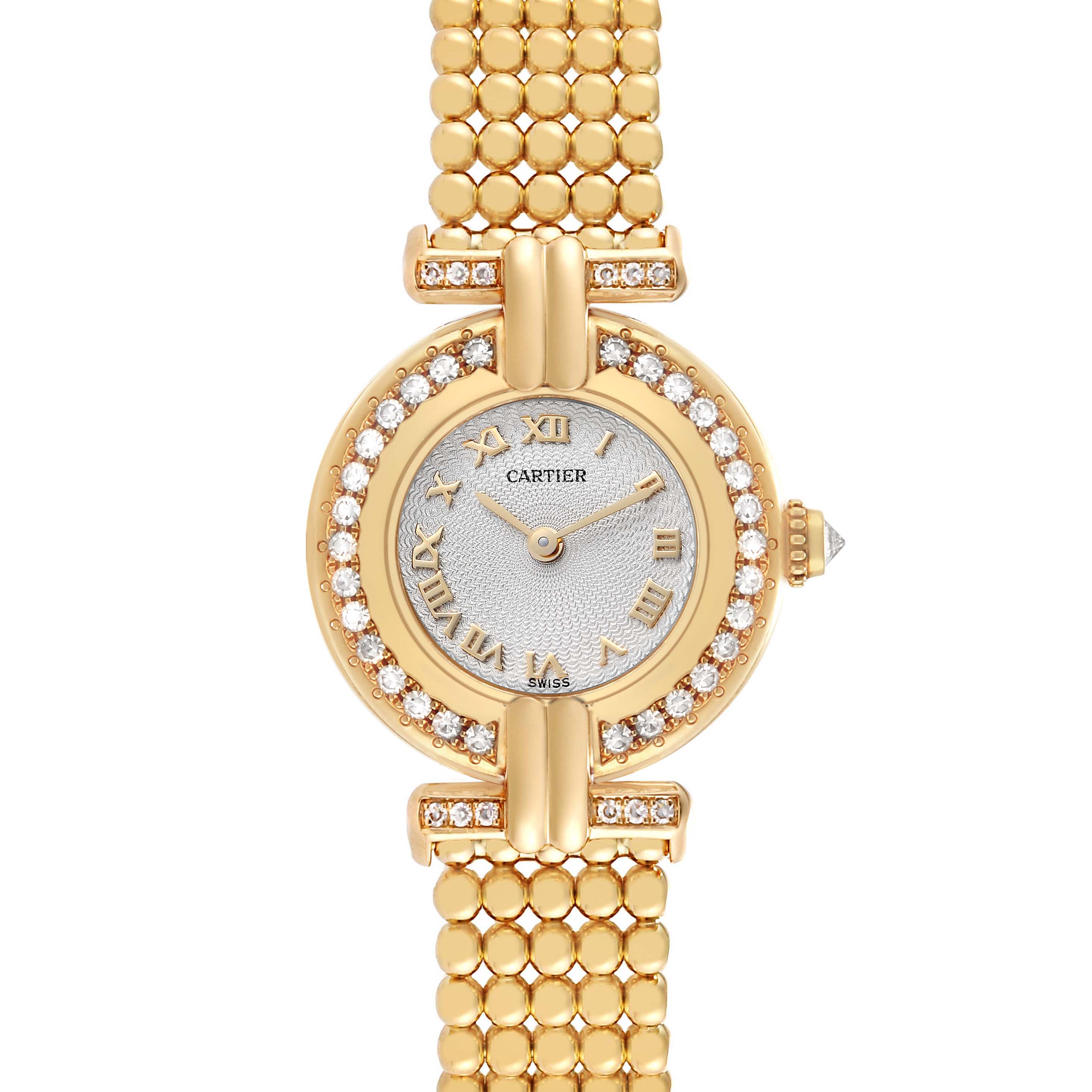 The Cartier Colisee WB1018A8 Women
s Yellow Gold Silver Dial watch is shown from a top-down angle, displaying its diamond-studded bezel, round face, and gold bracelet.