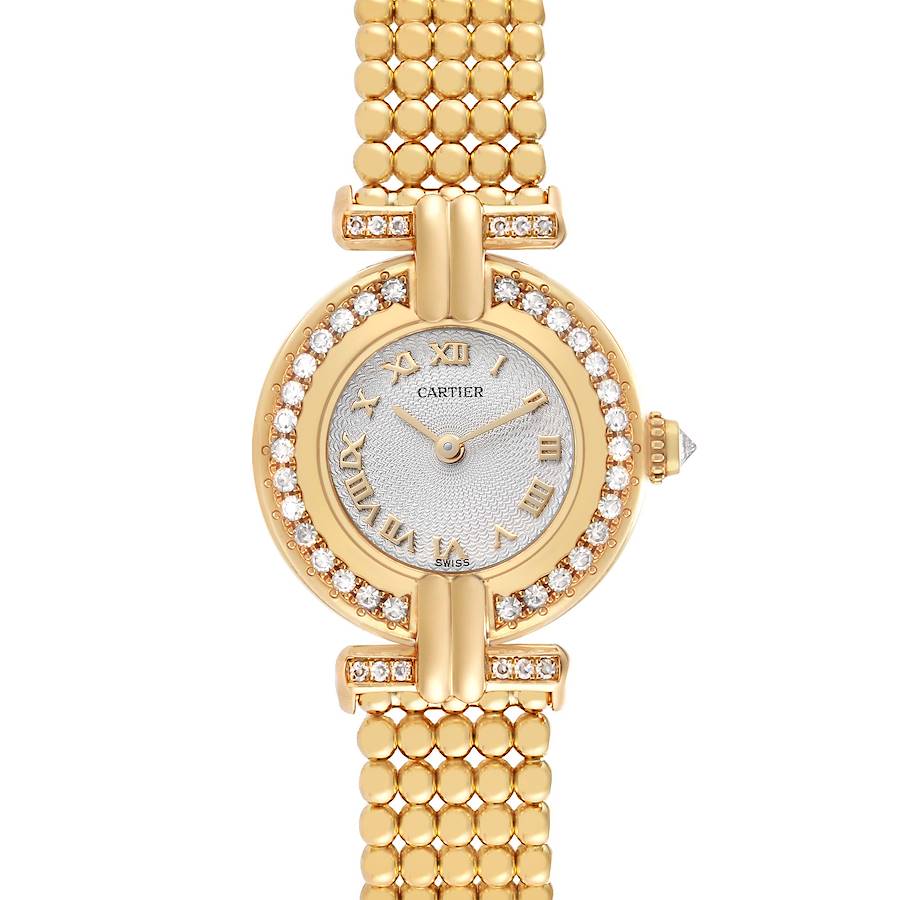 The Cartier Colisee WB1018A8 Women's Yellow Gold Silver Dial watch is shown from a top-down angle, displaying its diamond-studded bezel, round face, and gold bracelet.