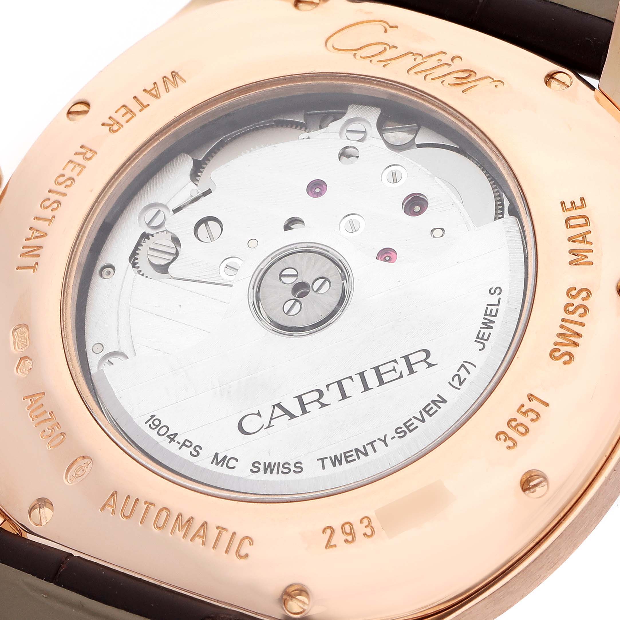 The image shows the back of the Calibre de Cartier watch, revealing its automatic movement and internal mechanics.