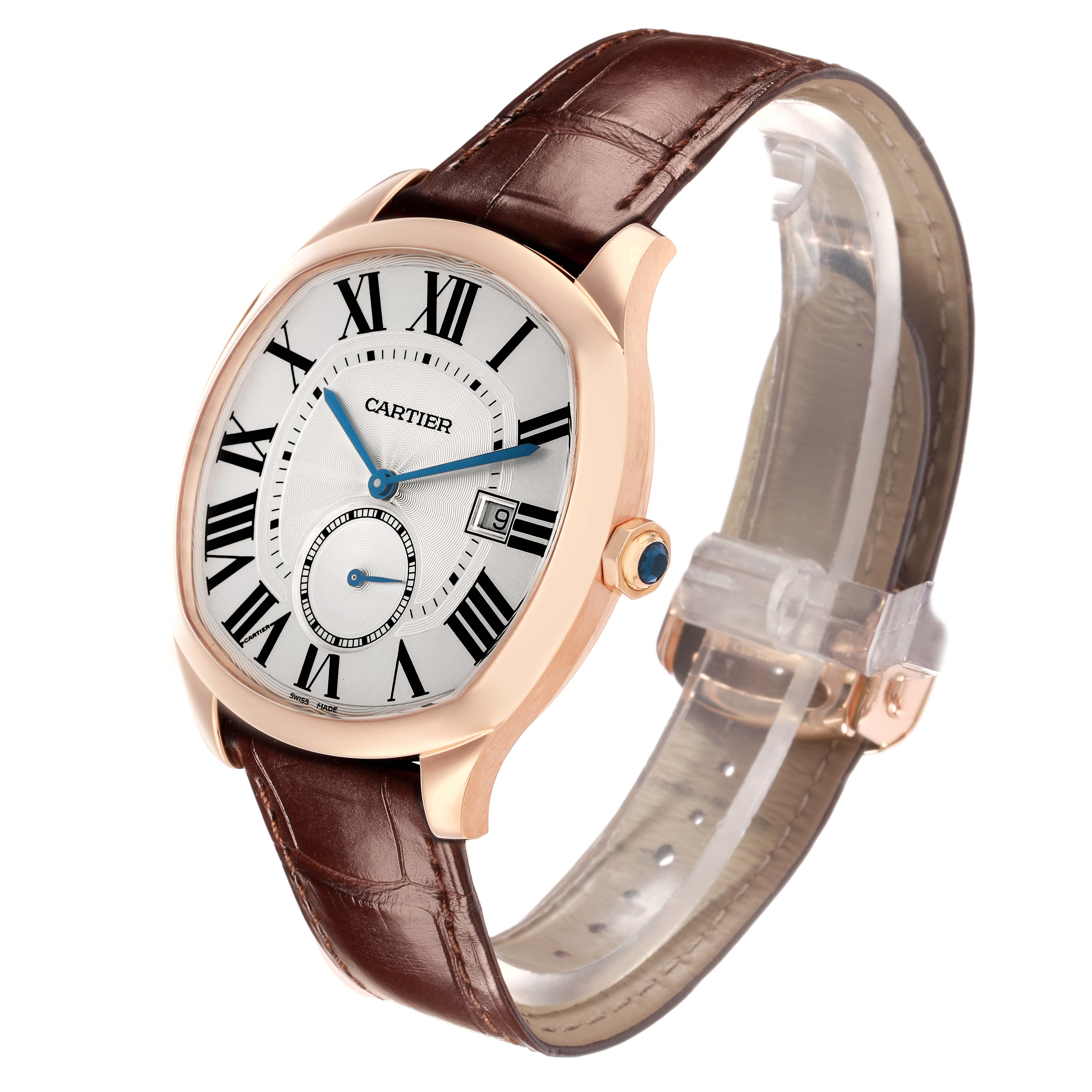 The Calibre de Cartier watch is angled to show the face, Roman numerals, date window, crown, and brown leather strap.
