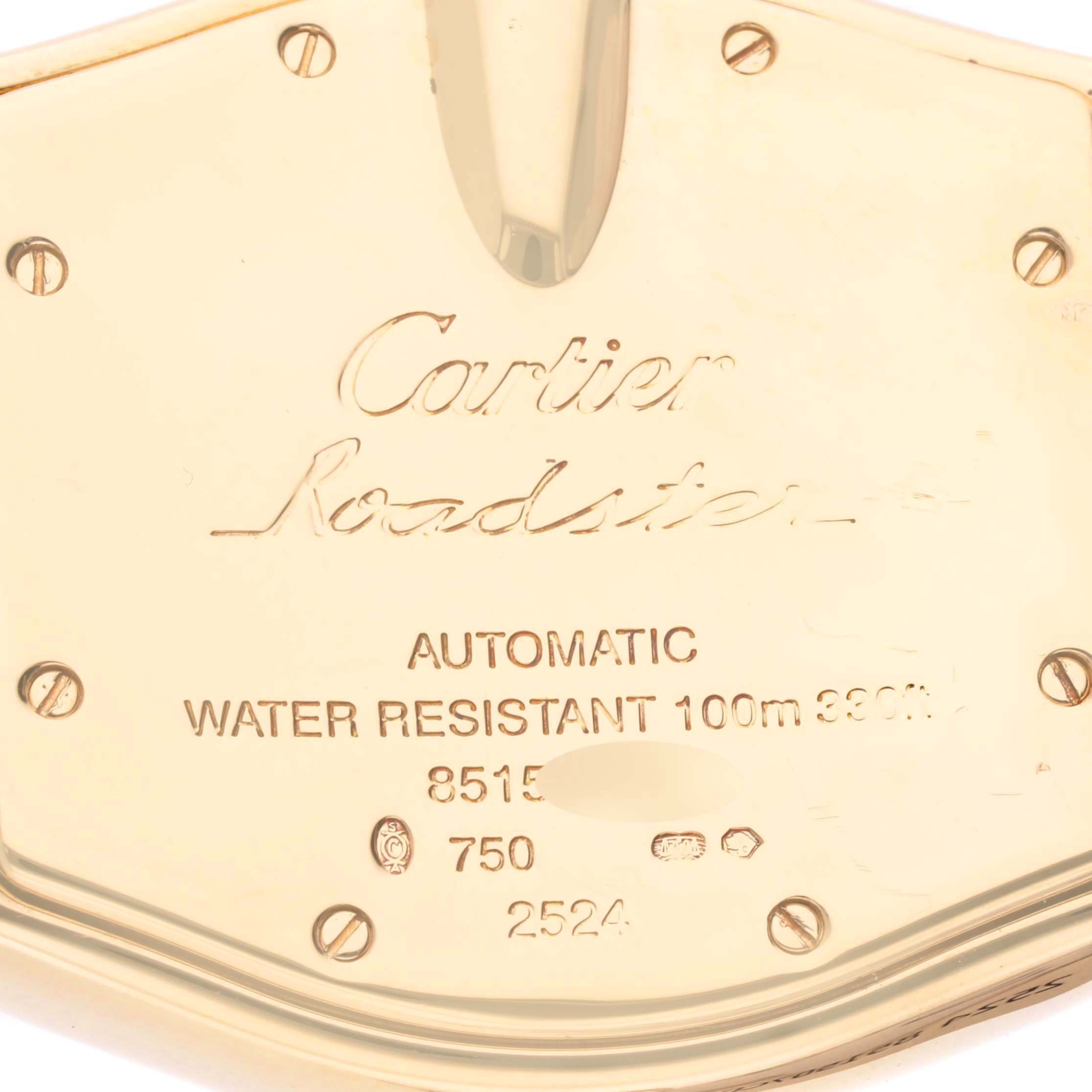 The image shows the back of a Cartier Roadster W62005V2 Men's Yellow Gold Silver Dial W62005V2 Men's Yellow Gold Silver Dial watch, displaying engraving details and screws.