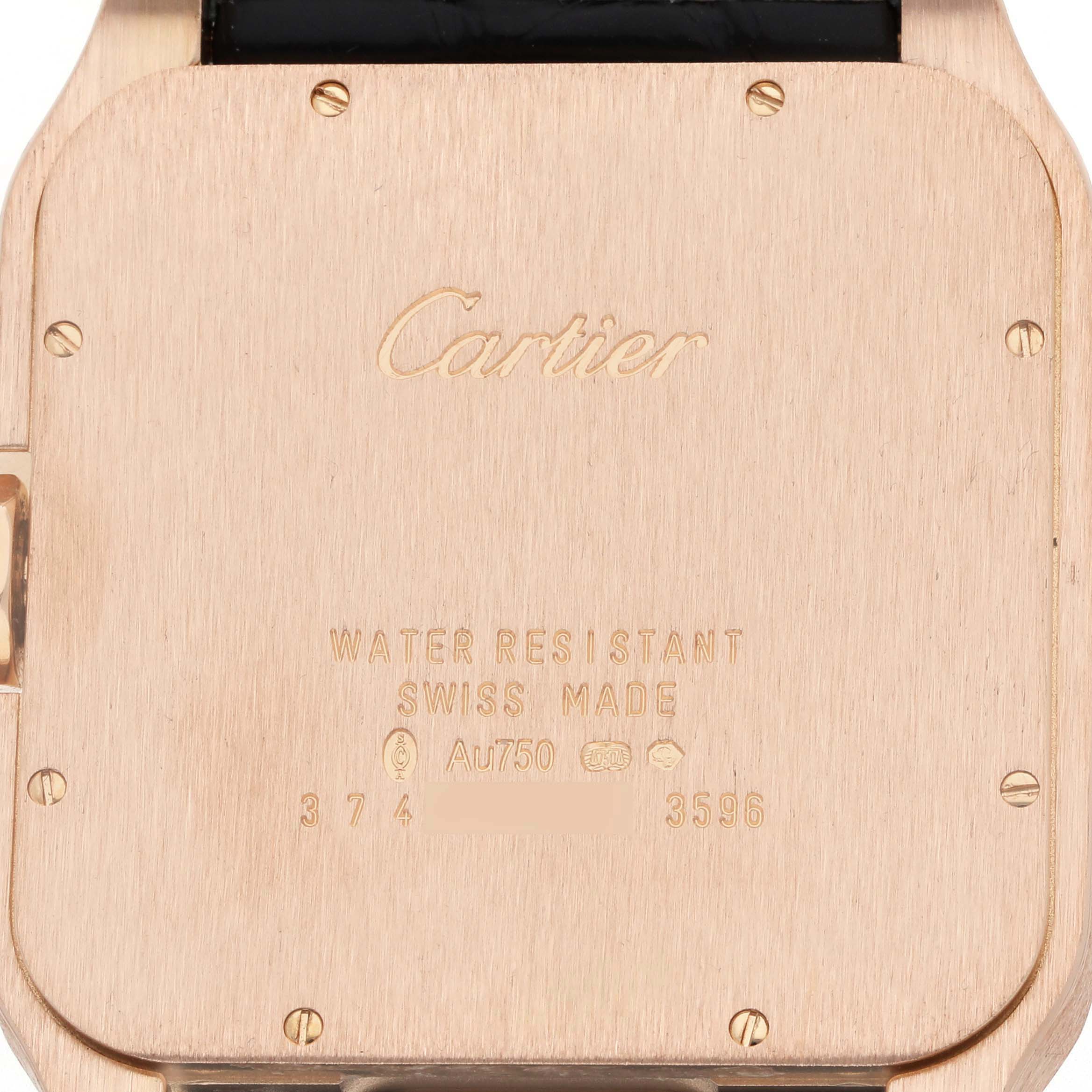 The image shows the back of a Cartier Santos Dumont W2020067 Men
s Rose Gold Silver Dial watch, featuring engravings and screws.