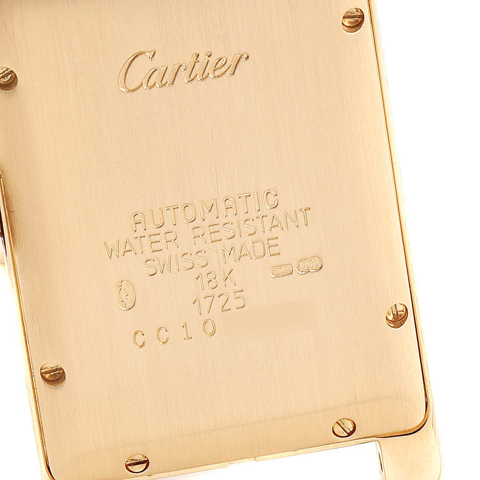 The image shows the case back of a Tank Americaine model by Cartier, highlighting engravings and screws.