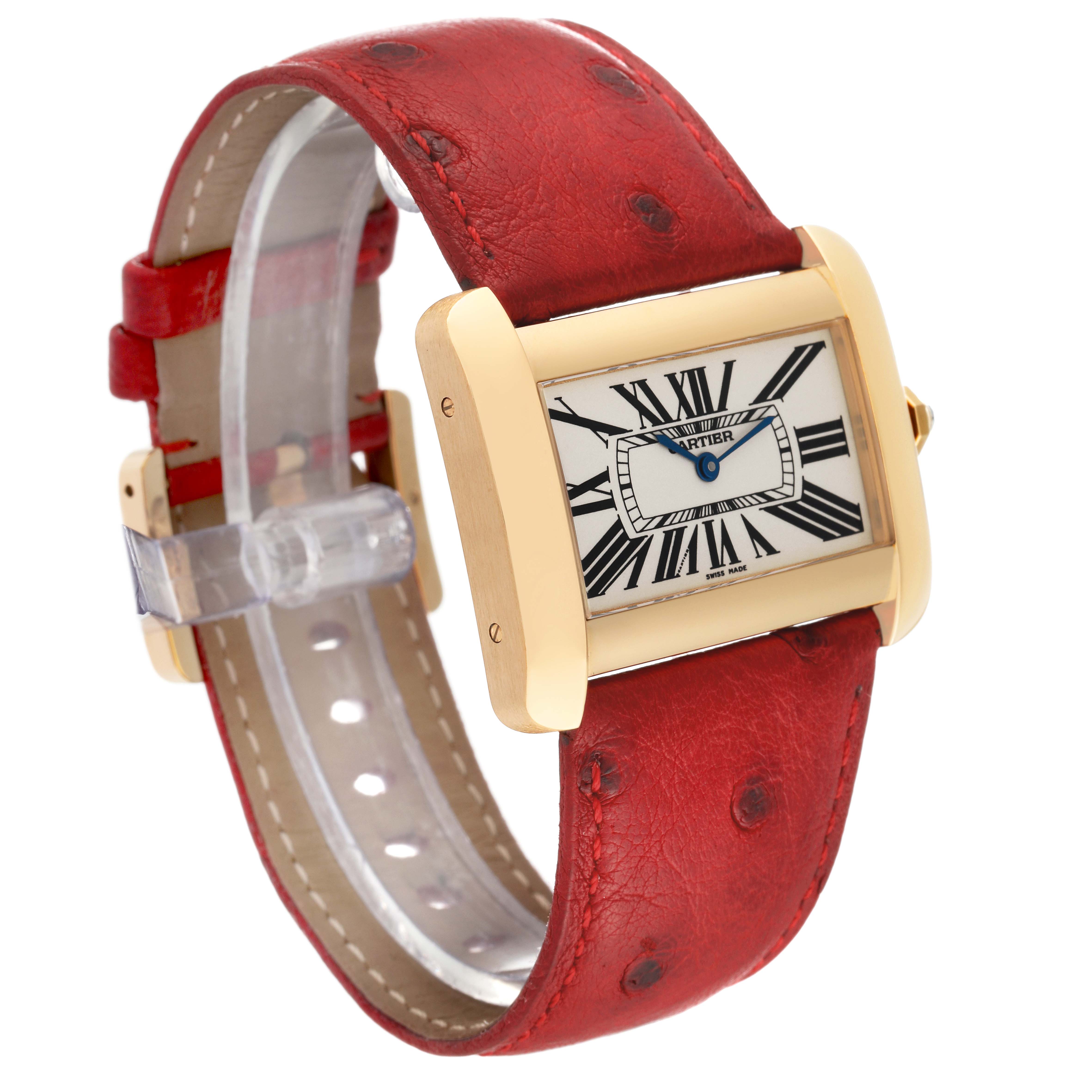The image shows a Cartier Tank Divan W6300556‏ Women
s Yellow Gold Silver Dial W6300556‏ Women
s Yellow Gold Silver Dial watch from an angled side view, highlighting the watch face and red leather strap.