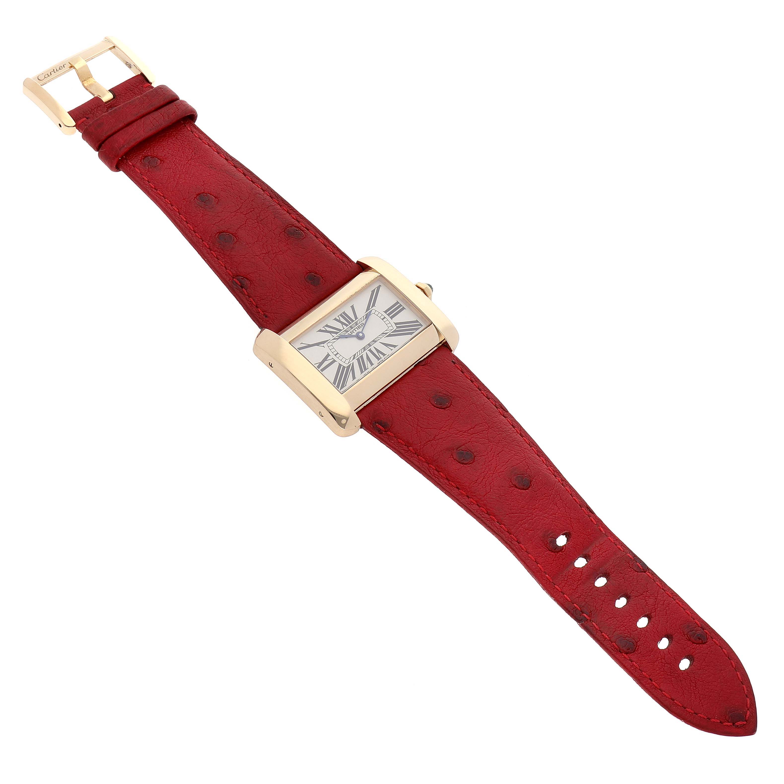 The image shows a Cartier Tank Divan W6300556‏ Women
s Yellow Gold Silver Dial W6300556‏ Women
s Yellow Gold Silver Dial watch, viewed from a top-down angle, displaying the face, case, red leather strap, and buckle.