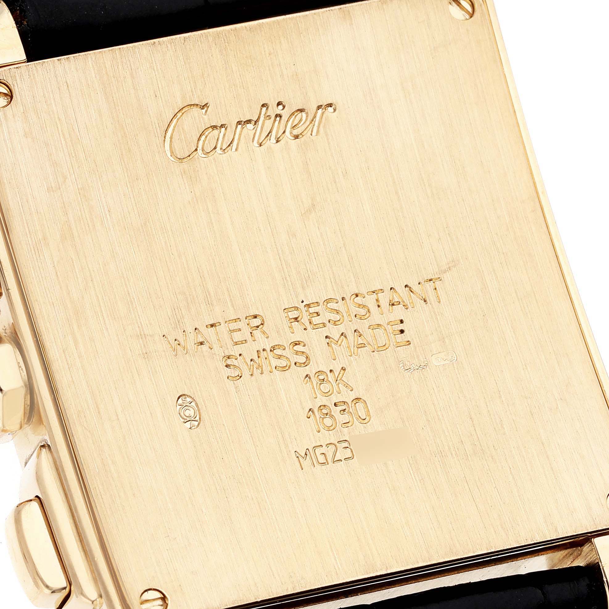 The image shows the back view of a Cartier Tank Francaise W5000556 Men's Yellow Gold Silver Dial W5000556 Men's Yellow Gold Silver Dial model watch, highlighting its markings and engravings.