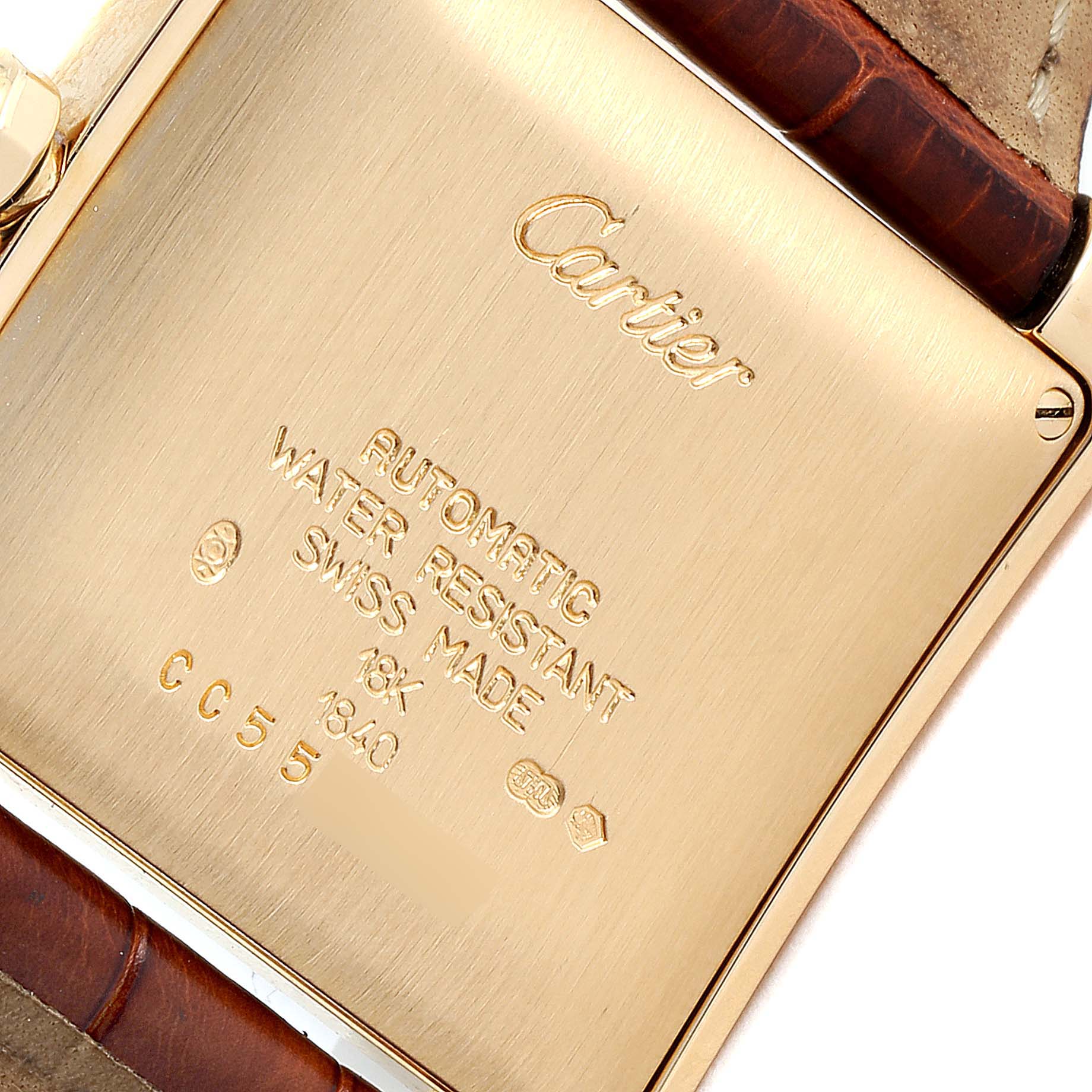 This image shows the case back of the Cartier Tank Française watch, highlighting its engravings and leather strap attachment.