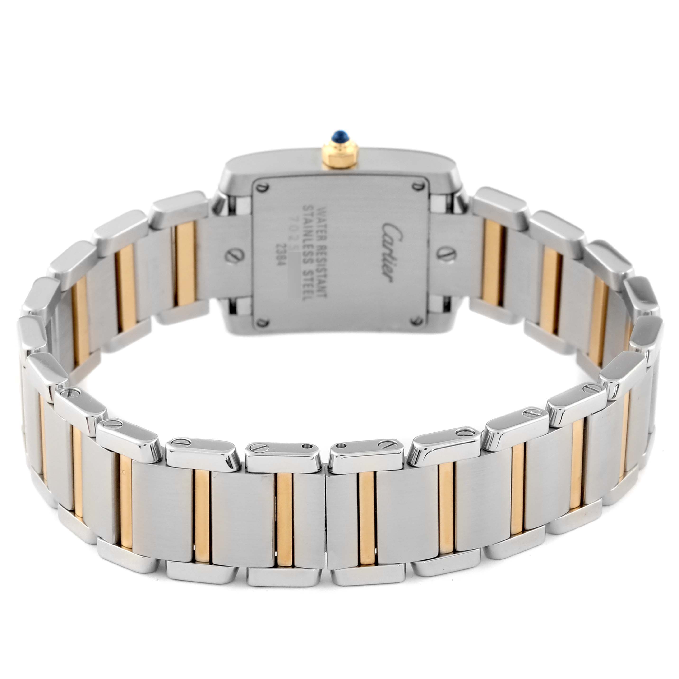 The image shows the back of a Cartier Tank Française watch, focusing on the two-tone bracelet and case back.