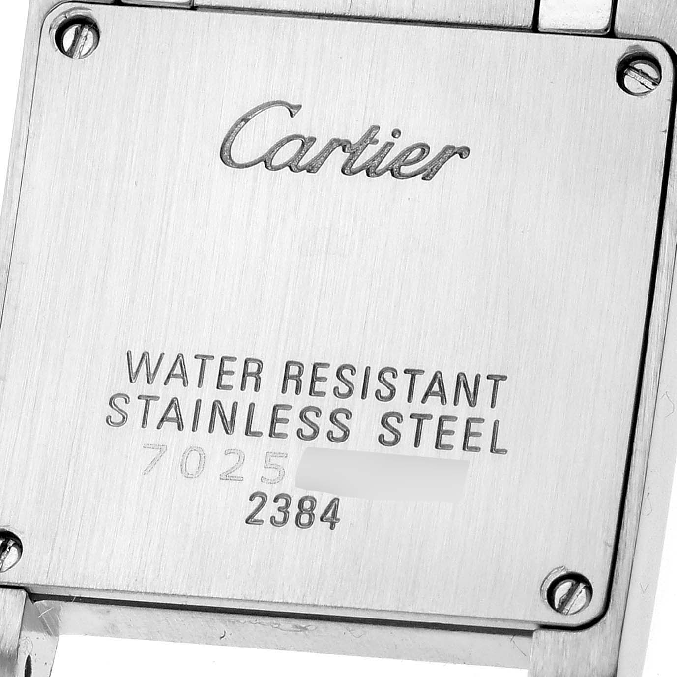 This image shows the back case of a Cartier Tank Française watch, featuring engraving details and screws.