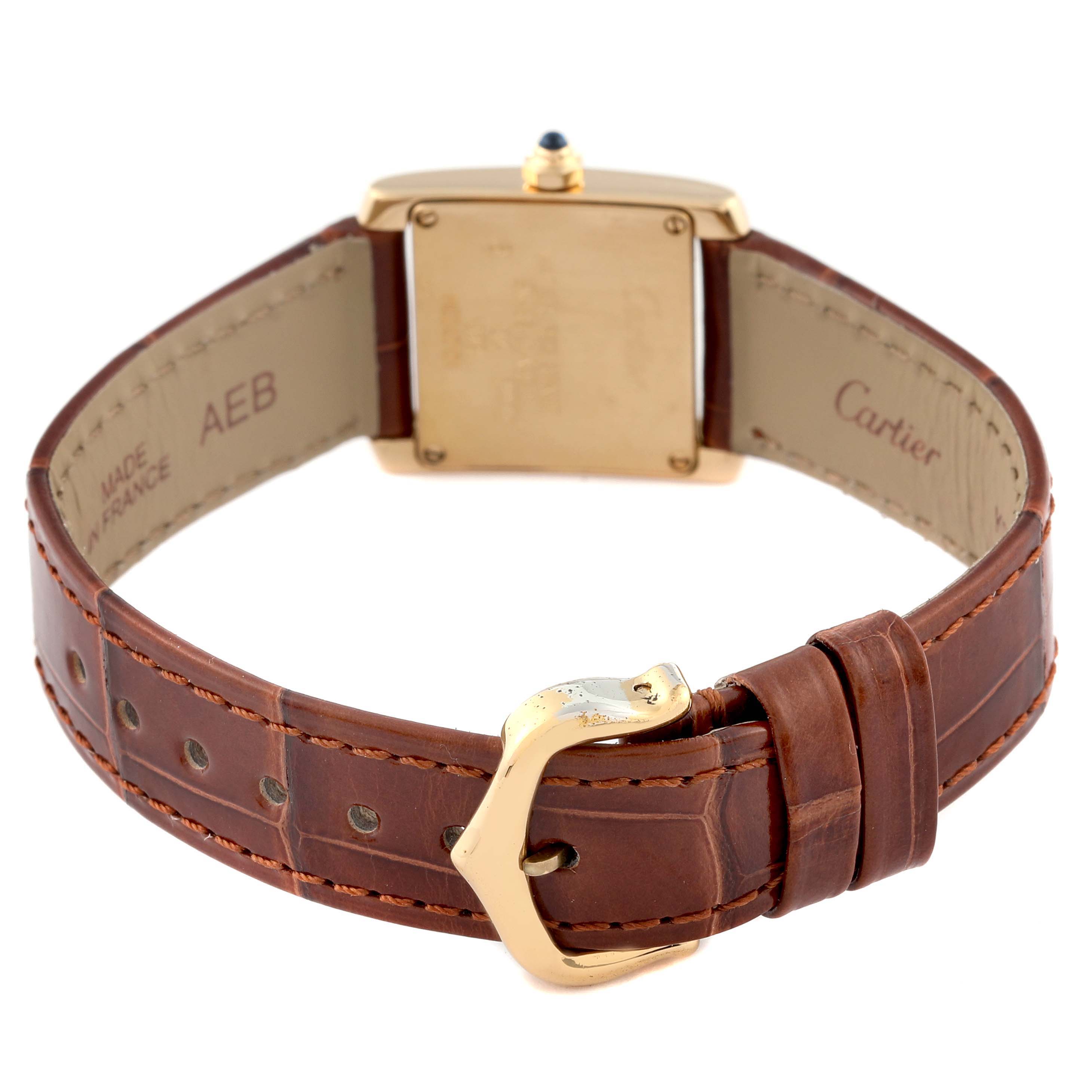 The Cartier Tank Francaise W5000256 Women's Yellow Gold Silver Dial W5000256 Women's Yellow Gold Silver Dial watch is viewed from the back, showing the case back and leather strap with the clasp.