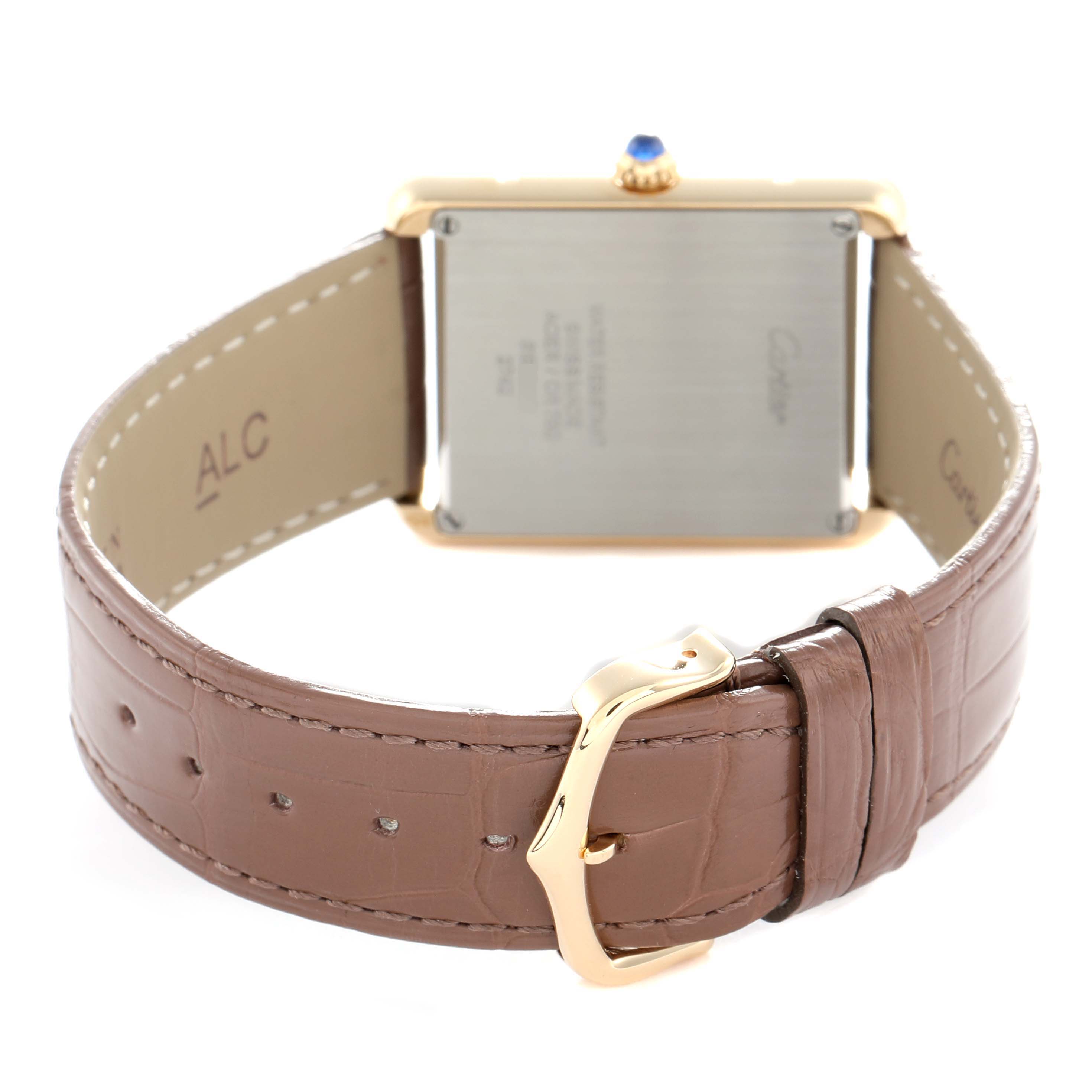 The image shows the back of the Cartier Tank Solo W1018855 Men
s Steel and Gold (two tone) Silver Dial watch, focusing on the case, crown, and brown leather strap with buckle.