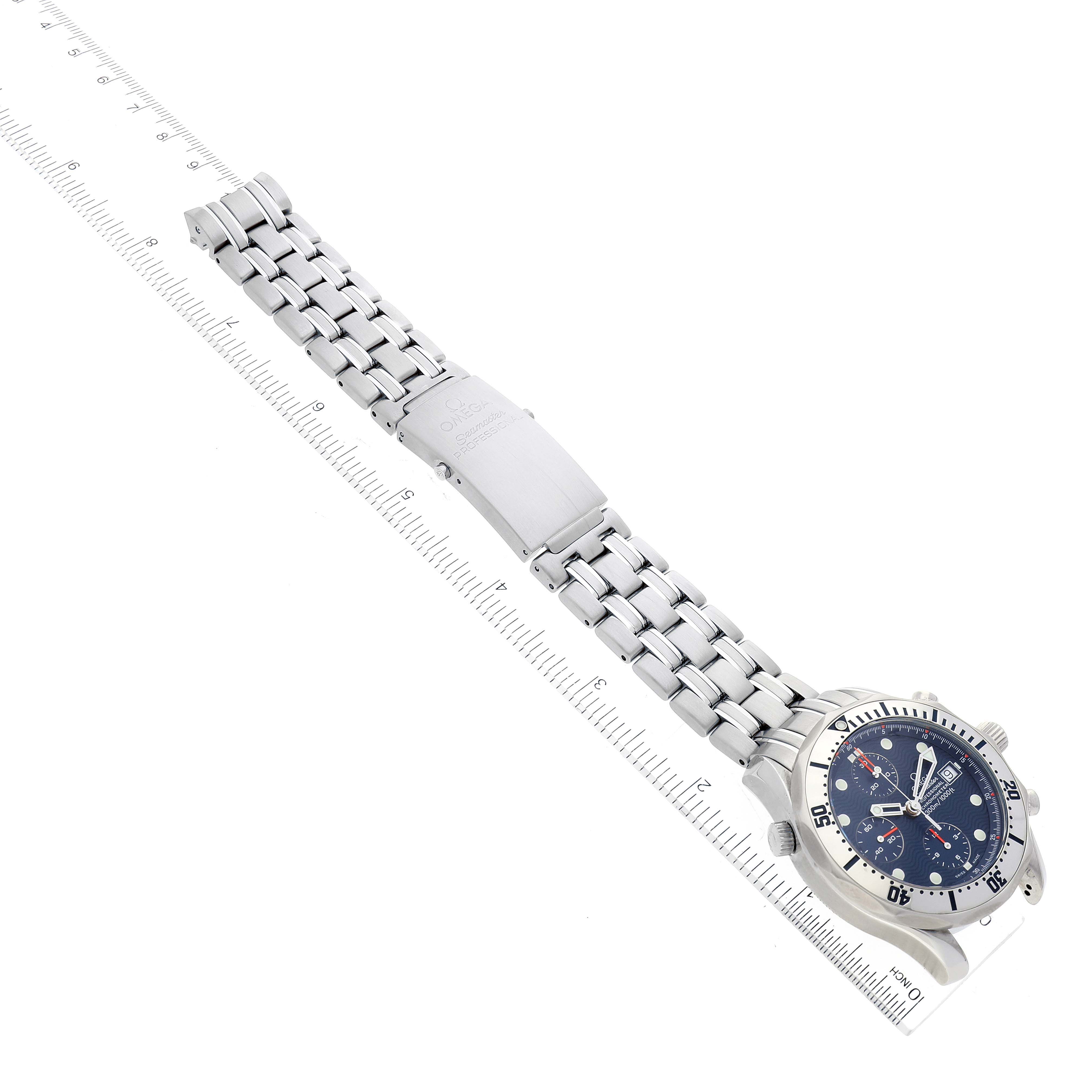 The image shows an Omega Seamaster 2598.80.00 Men's Stainless Steel Blue Dial 2598.80.00 Men's Stainless Steel Blue Dial watch lying flat, emphasizing the bracelet, clasp, and dial, against a ruler for scale.