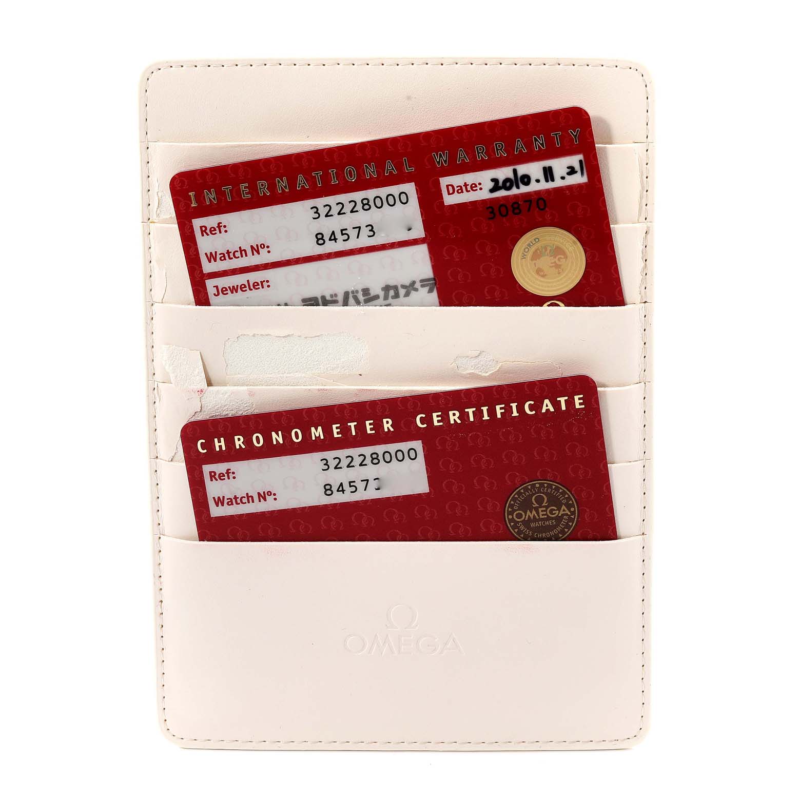 The image shows warranty and chronometer certificate cards for an Omega Speedmaster 3222.80.00 Men's Stainless Steel Blue Dial 3222.80.00 Men's Stainless Steel Blue Dial, placed in a cream-colored cardholder.