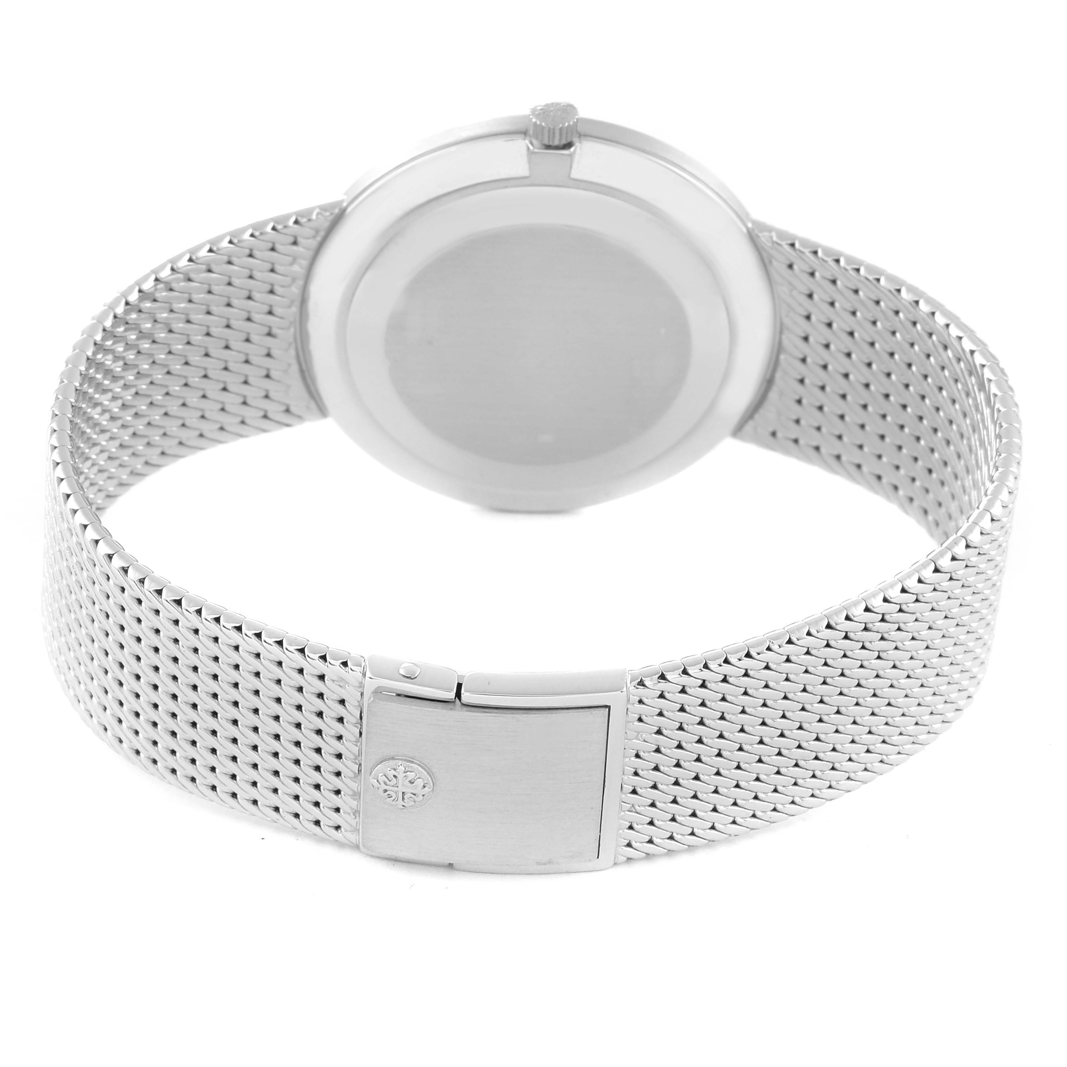 The image shows the backside and clasp of a Patek Philippe Calatrava 3919G Men's White Gold White Dial 3919G Men's White Gold White Dial watch, highlighting its metal mesh bracelet.