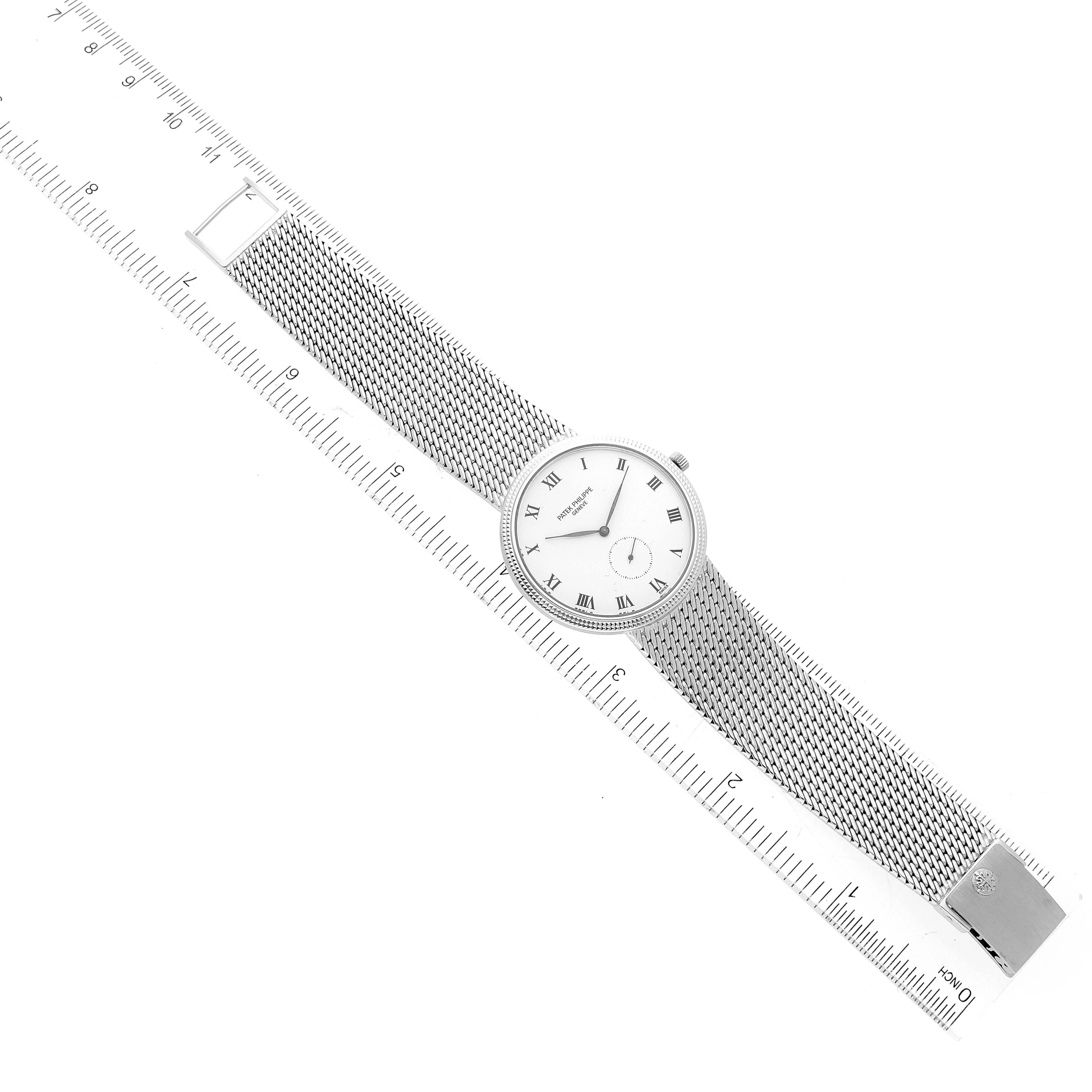 The image shows a top-down view of a Patek Philippe Calatrava 3919G Men's White Gold White Dial 3919G Men's White Gold White Dial watch, including the face, mesh band, and clasp, measured against a ruler.