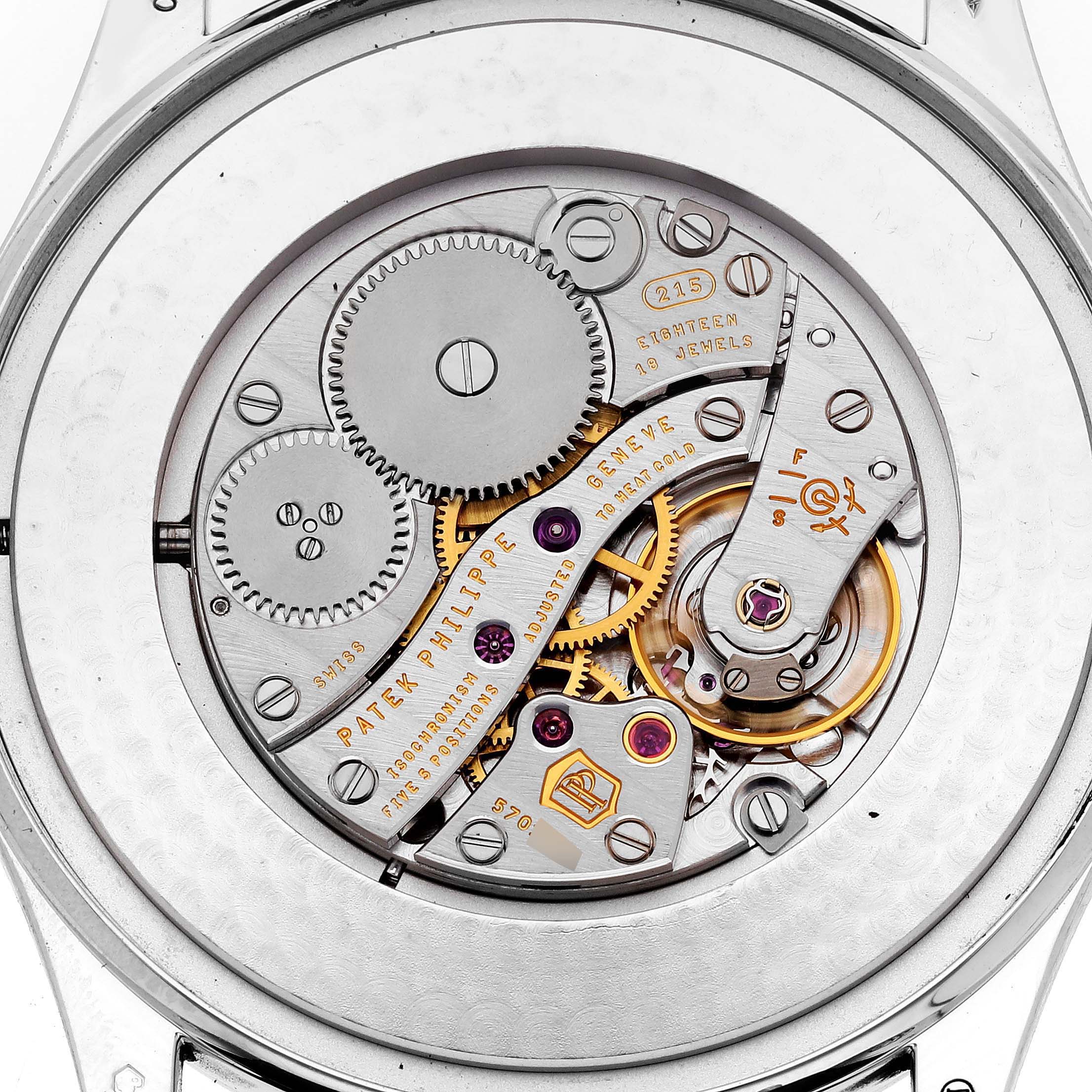 The image shows a Patek Philippe Calatrava 5196P-001 Men's Platinum Silver Dial 5196P-001 Men's Platinum Silver Dial model with its movement and intricate mechanical parts visible.