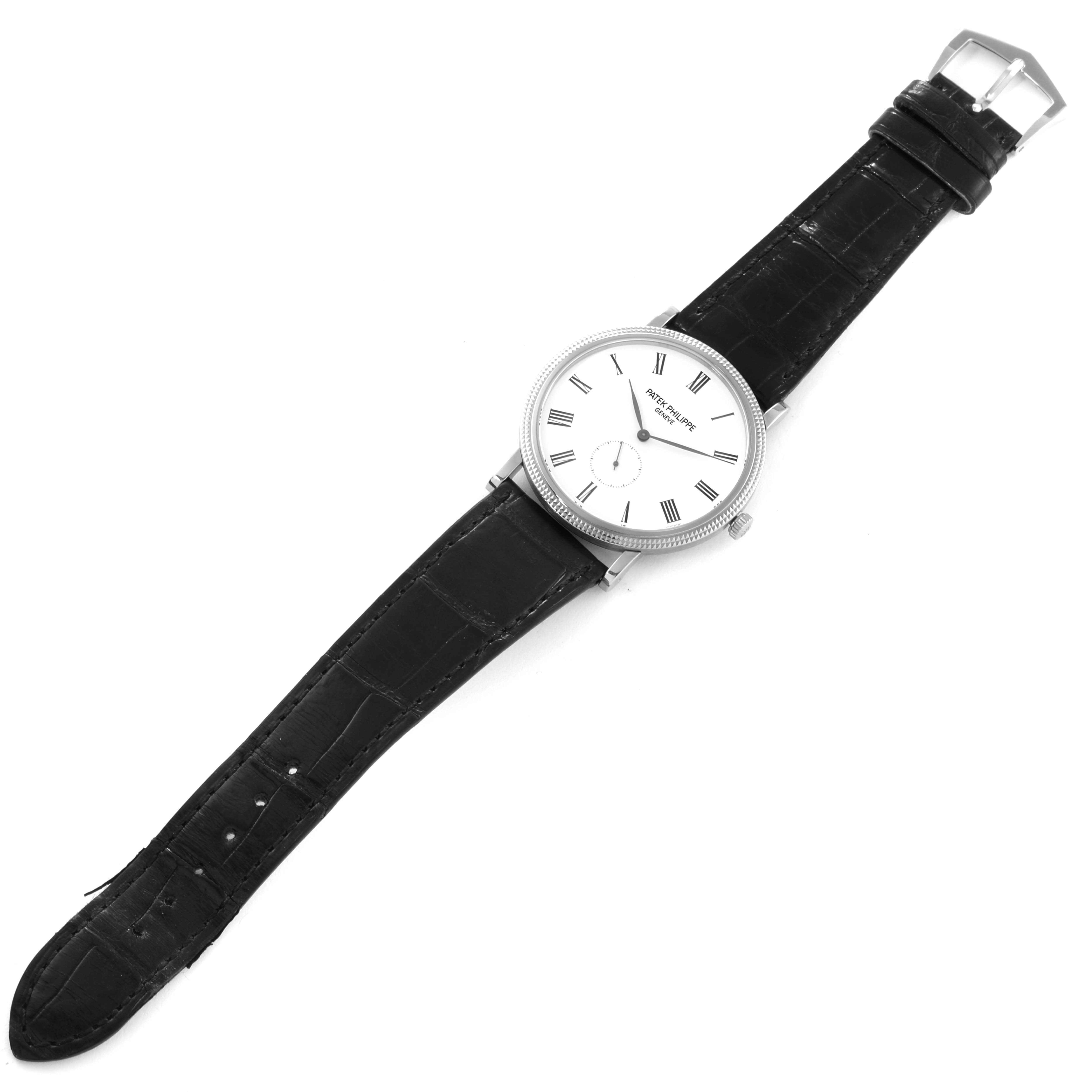 The image shows a Patek Philippe Calatrava 5119G Men
s White Gold White Dial 5119G Men
s White Gold White Dial watch from a top-down angle, displaying the entire face, strap, and buckle.