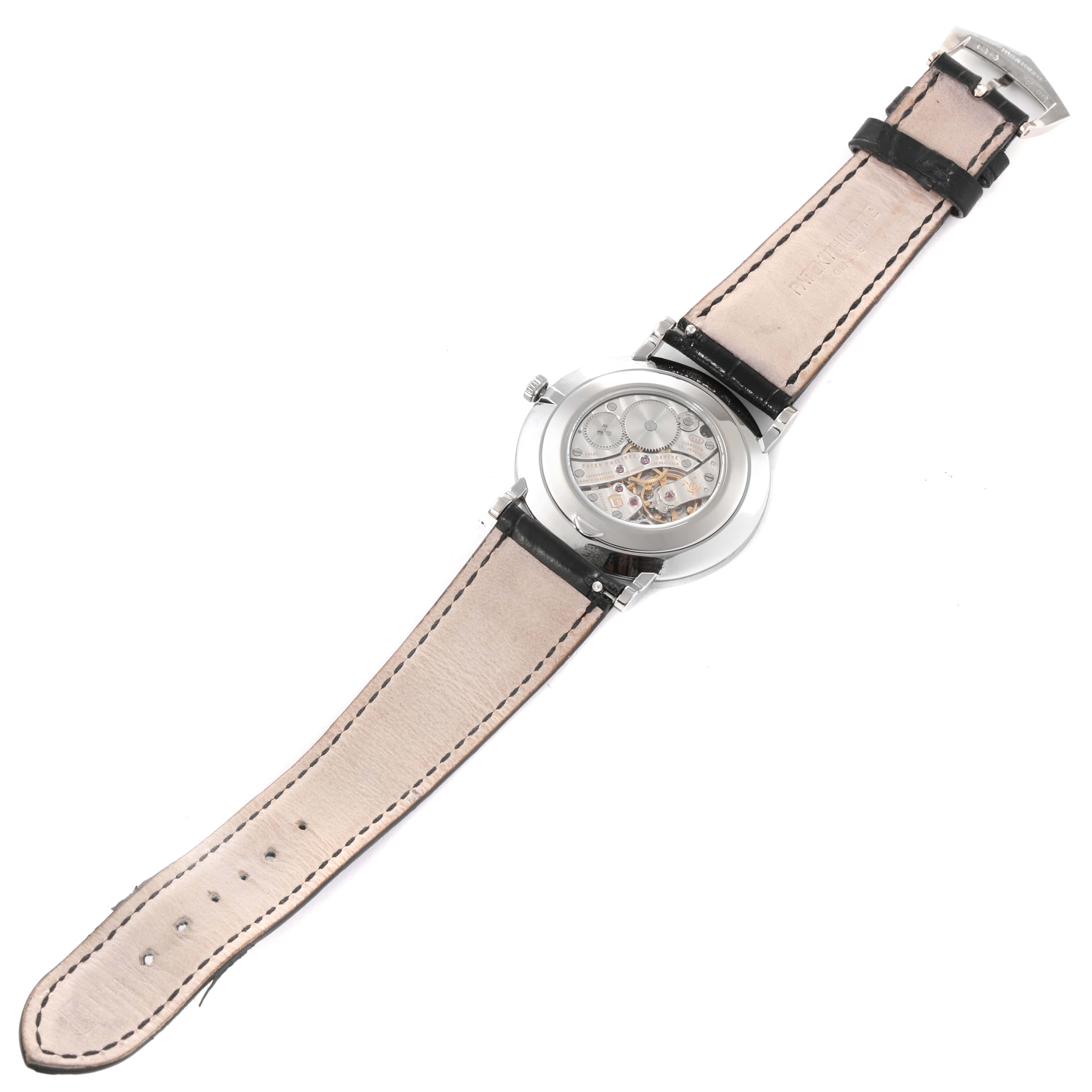 The image shows the back view of a Patek Philippe Calatrava 5119G Men
s White Gold White Dial 5119G Men
s White Gold White Dial watch, highlighting its strap and exposed mechanical movement.