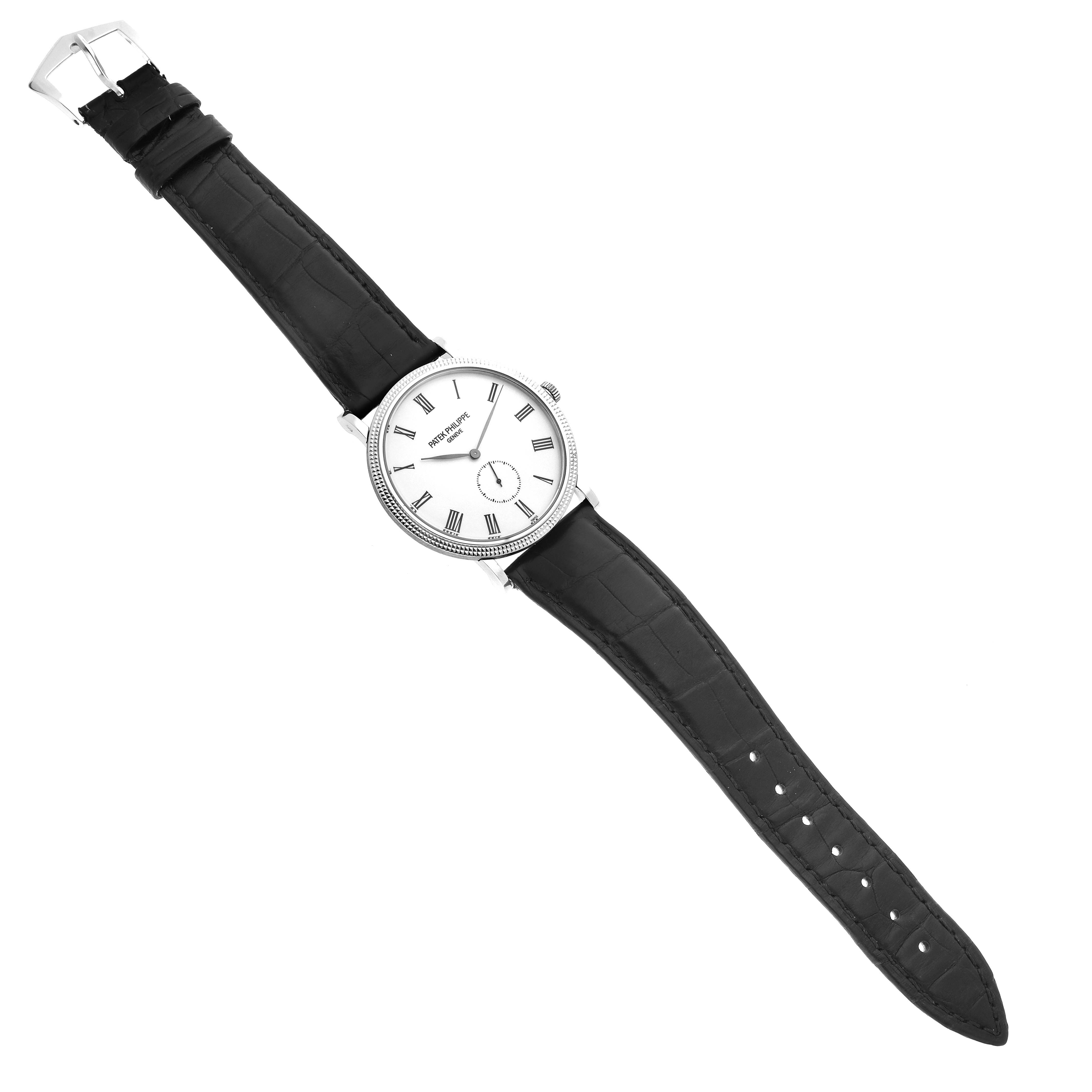 The Patek Philippe Calatrava 5119G-001 Men's White Gold White Dial 5119G-001 Men's White Gold White Dial watch is shown from a top-down angle, featuring the dial, bezel, and leather strap.