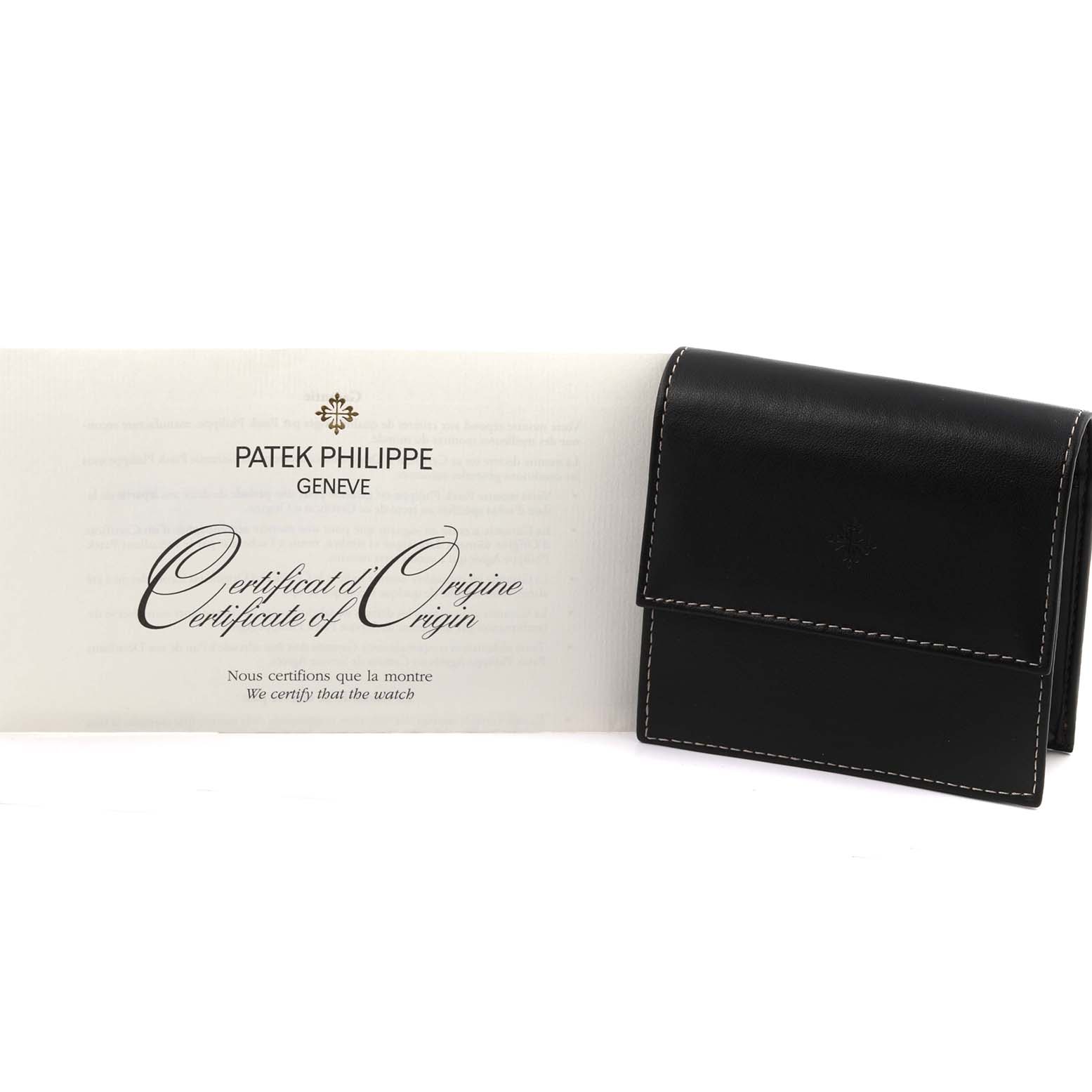 The image shows a Patek Philippe Calatrava 5119G-001 Men's White Gold White Dial 5119G-001 Men's White Gold White Dial certificate of origin and a black leather pouch.