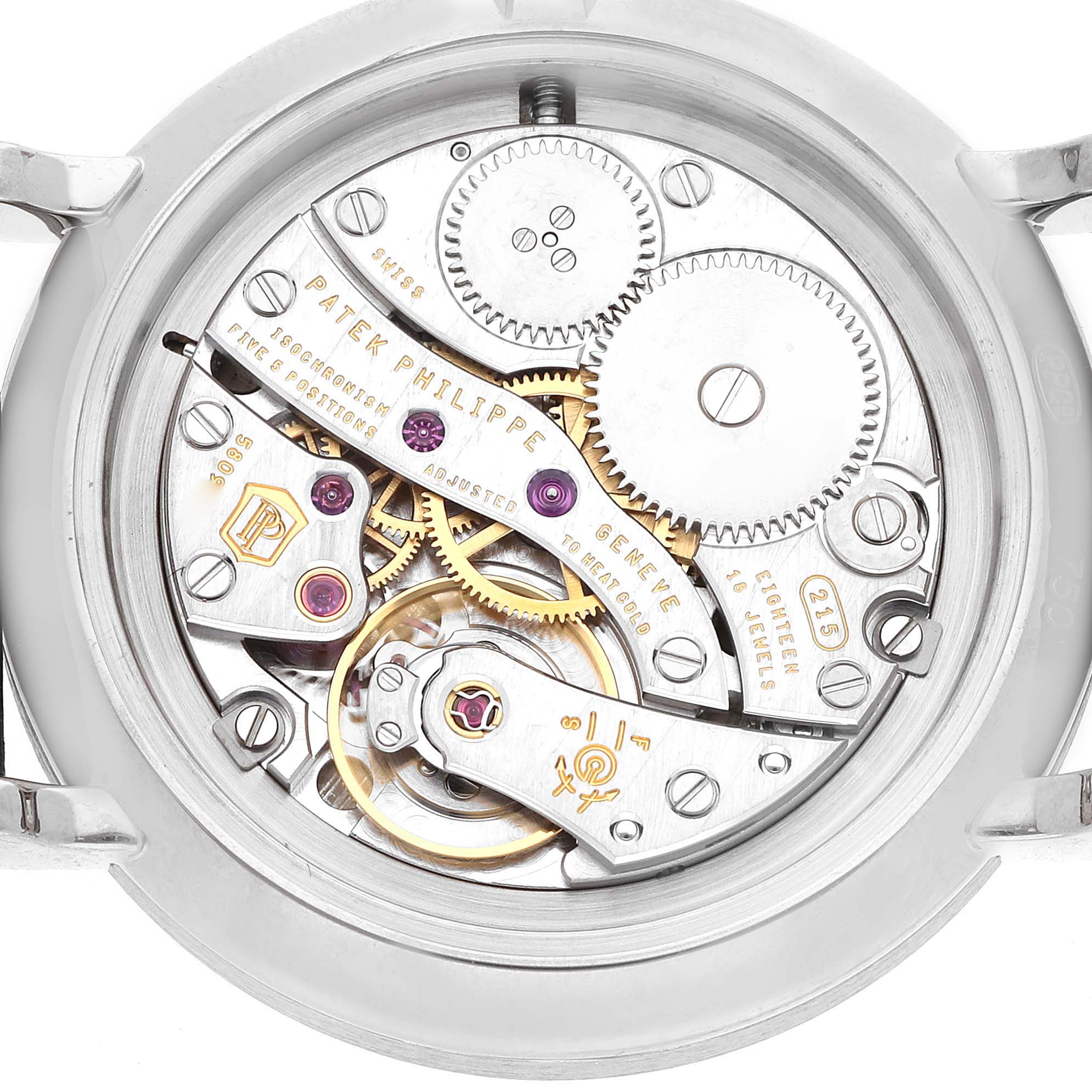 The image shows the intricate movement of a Patek Philippe Calatrava 7120G-001 Women
s White Gold Beige Dial watch from the back, showcasing gears and mechanical components.