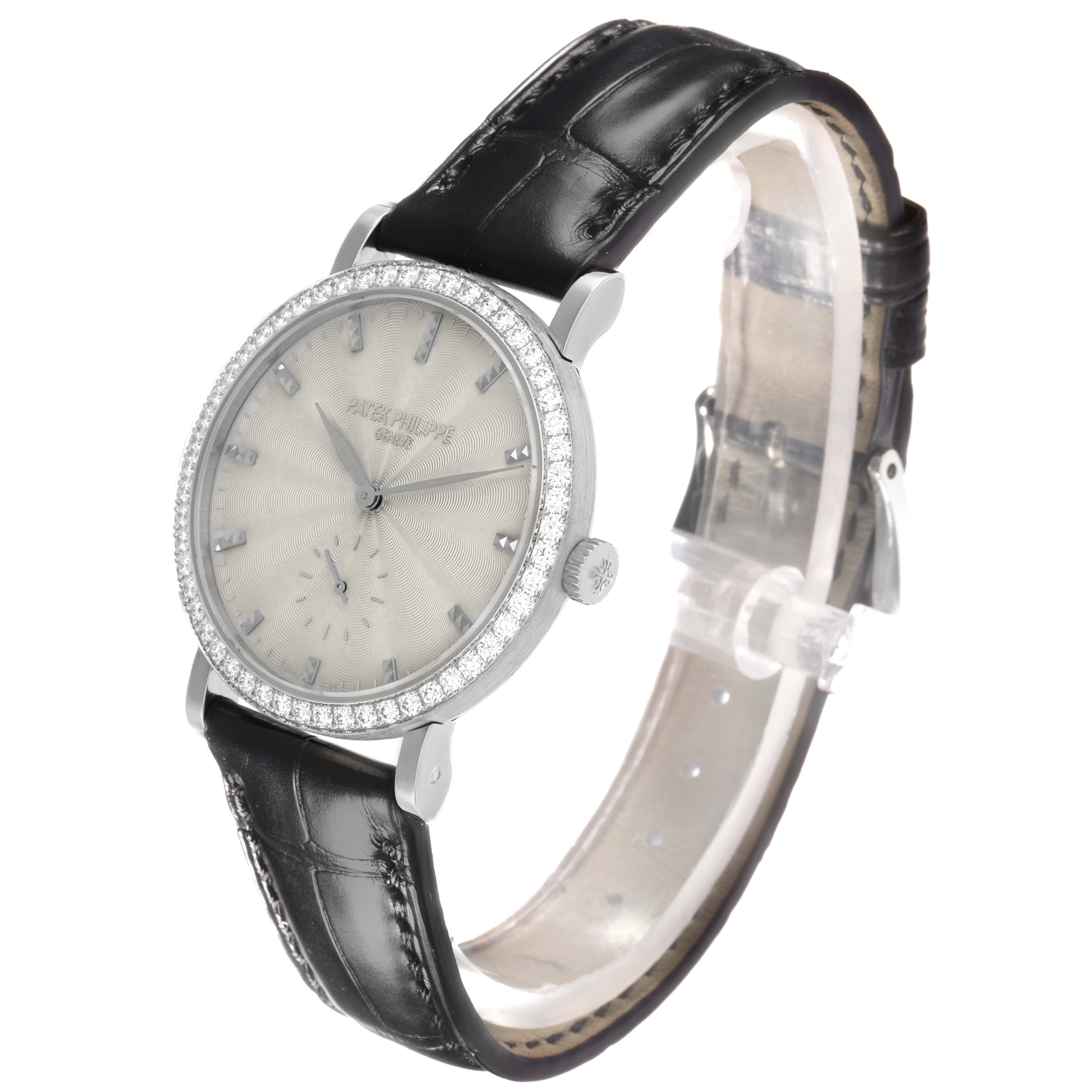 The Patek Philippe Calatrava 7120G-001 Women
s White Gold Beige Dial watch is shown at a slight side-angle, highlighting the face, bezel, crown, and leather strap.