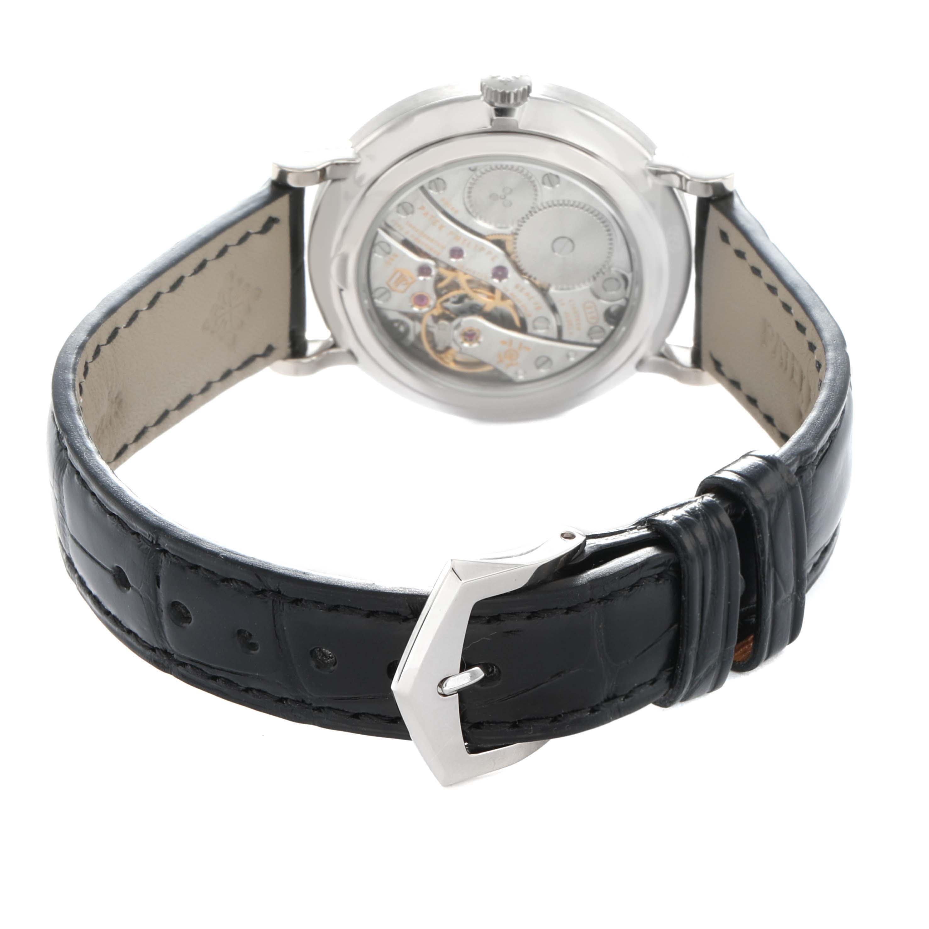 The Patek Philippe Calatrava 7120G-001 Women
s White Gold Beige Dial watch is shown from the back, displaying the transparent case back and leather strap.