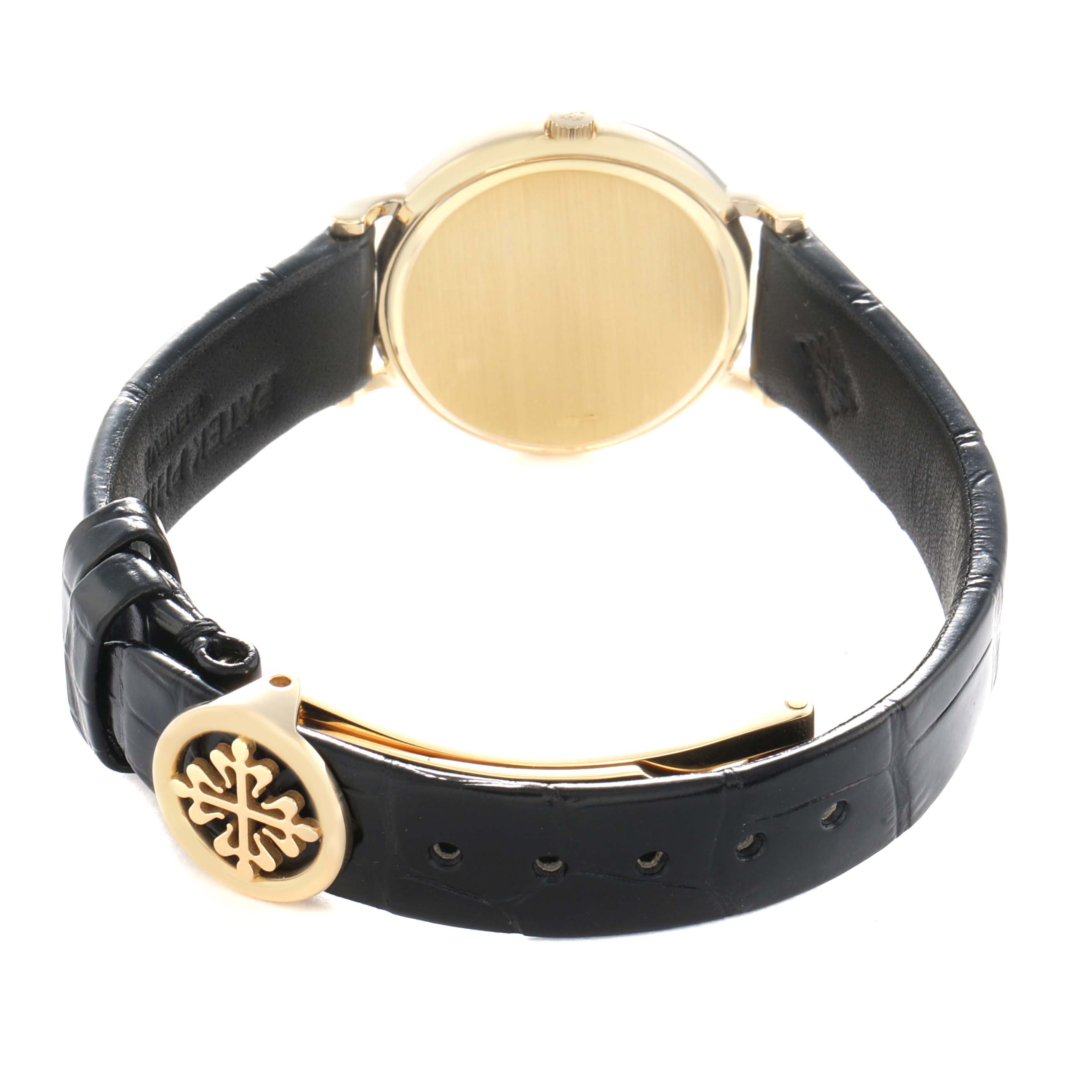 The image shows the back and side view of a Patek Philippe Calatrava 4819J Women
s Yellow Gold White Dial watch, highlighting the case back and leather strap with a logo clasp.