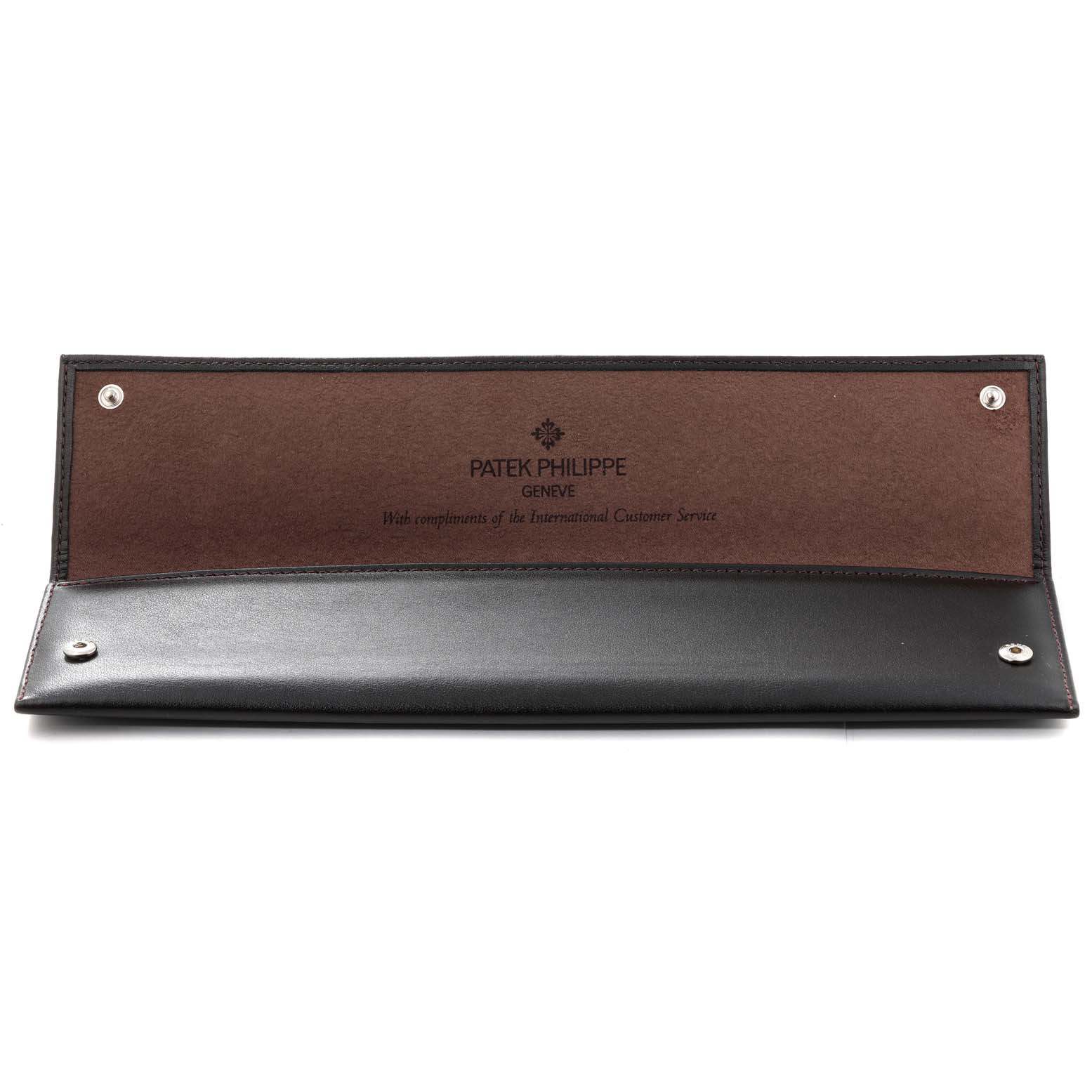 The image shows an opened Patek Philippe watch case for the Golden Ellipse model, displaying the inner leather lining and snap closures.