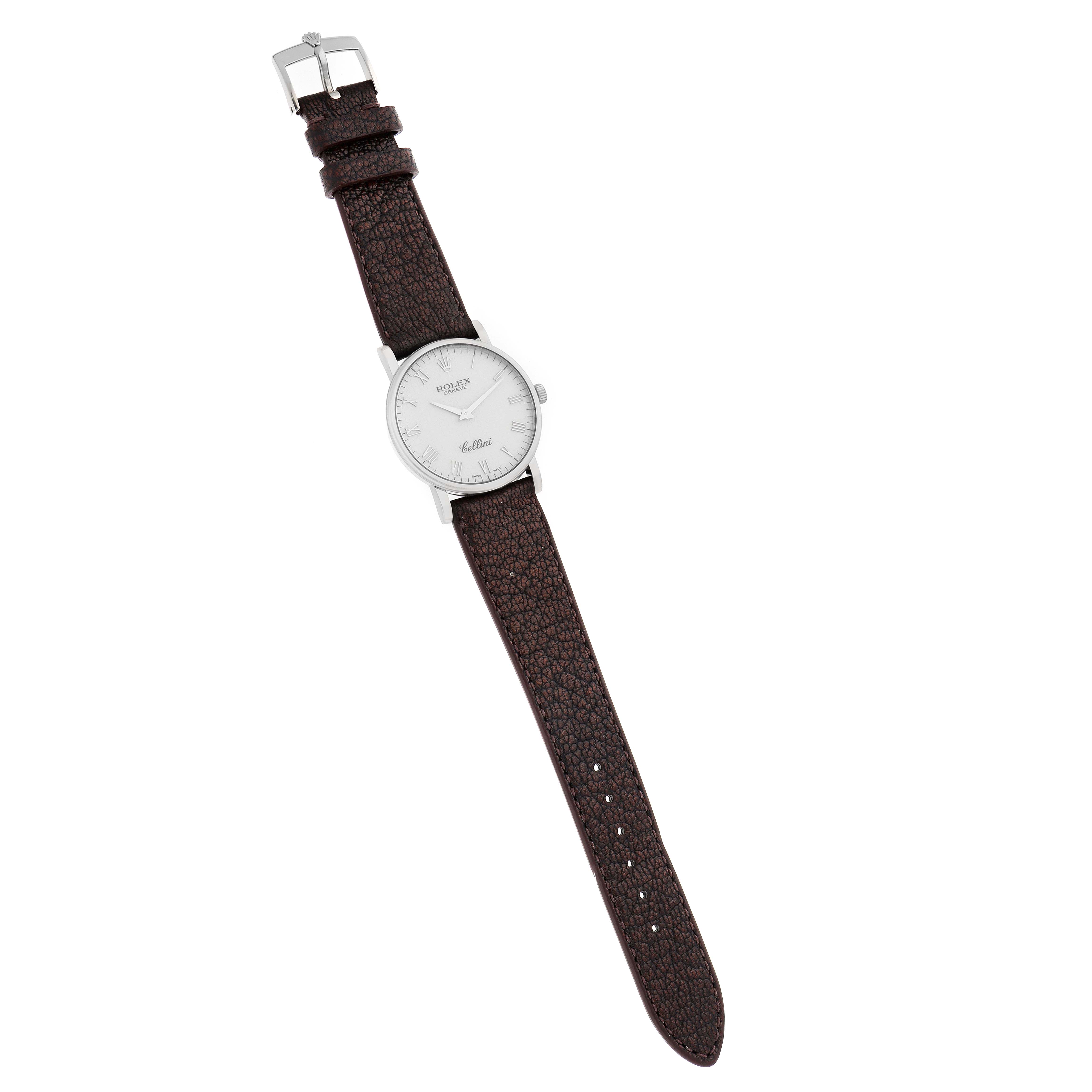 The Rolex Cellini 5115 Men
s White Gold Silver Dial watch is shown flat from above, displaying the face, crown, and entire leather strap with buckle.