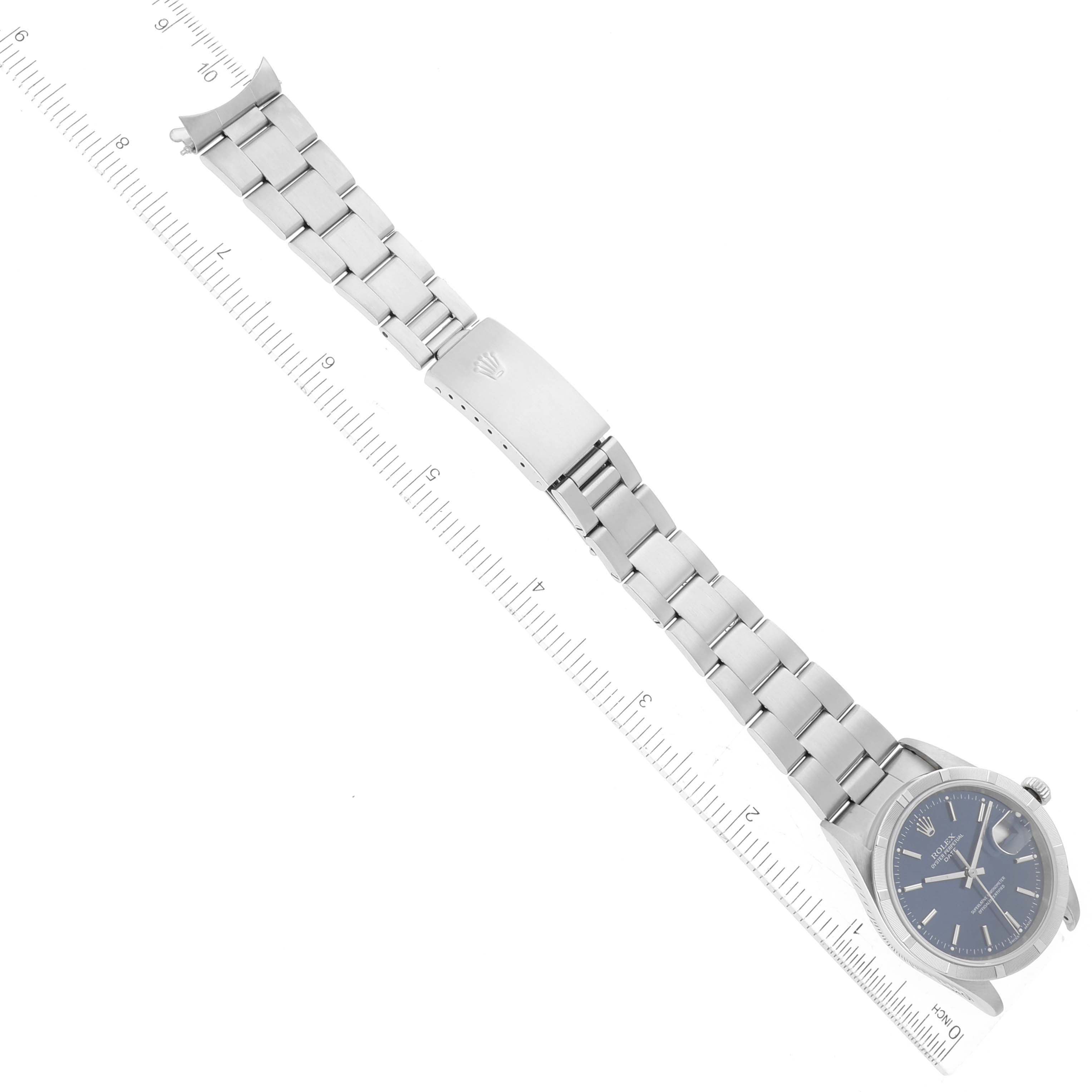The image shows a Rolex Date 15210 Men's Stainless Steel Blue Dial 15210 Men's Stainless Steel Blue Dial watch laid flat, highlighting its bracelet, clasp, and face, measured alongside a ruler.