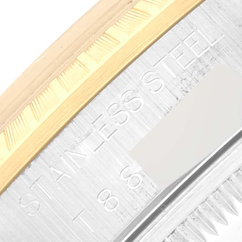 This image shows a close-up of the stainless steel and gold fluted bezel of a Rolex Date 15223 Men's Steel and Gold (two tone) Champagne Dial 15223 Men's Steel and Gold (two tone) Champagne Dial model watch.