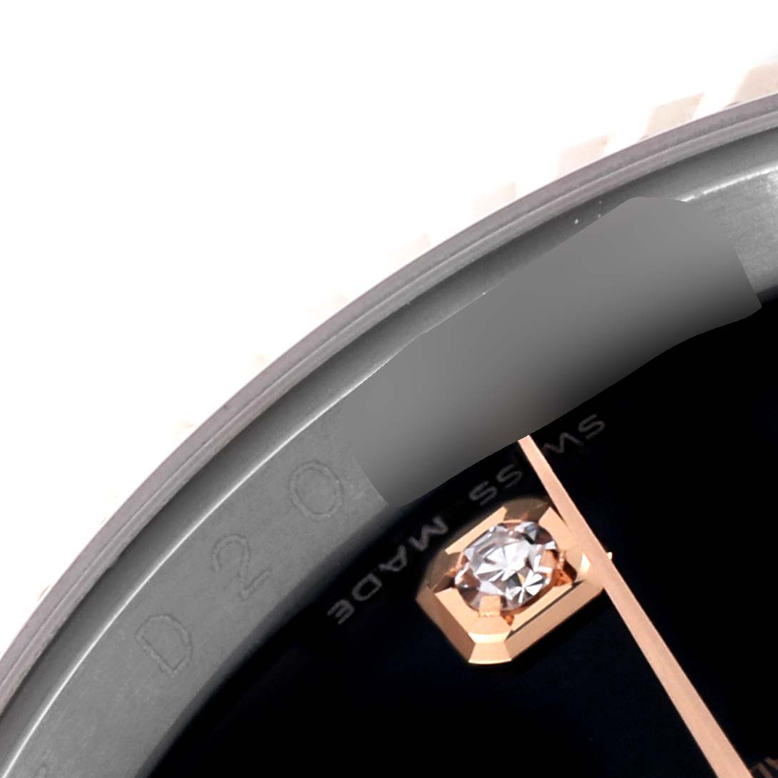 This is a close-up of the dial and bezel of a Rolex Datejust 116231 Men's Steel and Gold (two tone) Black Dial 116231 Men's Steel and Gold (two tone) Black Dial, showing a diamond marker and part of the "Swiss Made" text.