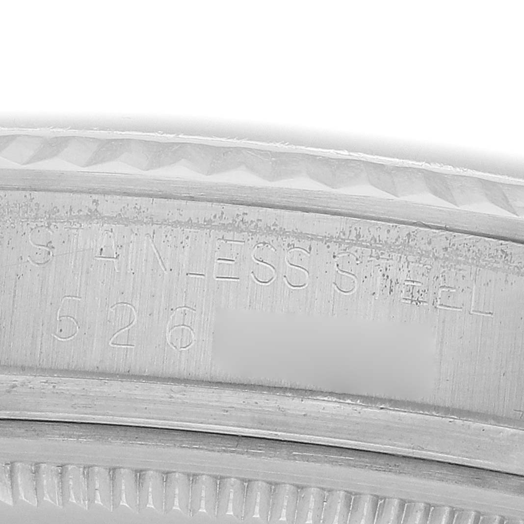 The image shows a close-up of the case engraving of a Rolex Datejust 16014 Men
s Stainless Steel Silver Dial, highlighting the words "STAINLESS STEEL" and part of the serial number.