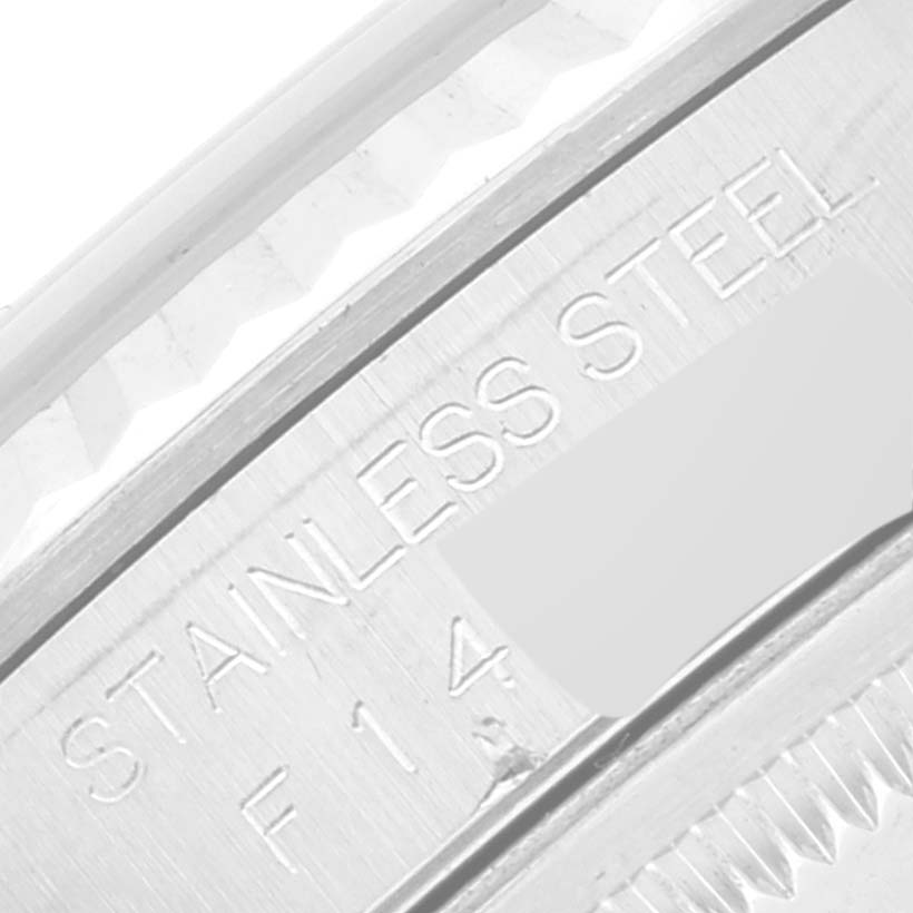This image shows a close-up of the side of a Rolex Datejust 16234 Men's Stainless Steel Silver Dial 16234 Men's Stainless Steel Silver Dial watch highlighting the "STAINLESS STEEL" engraving.