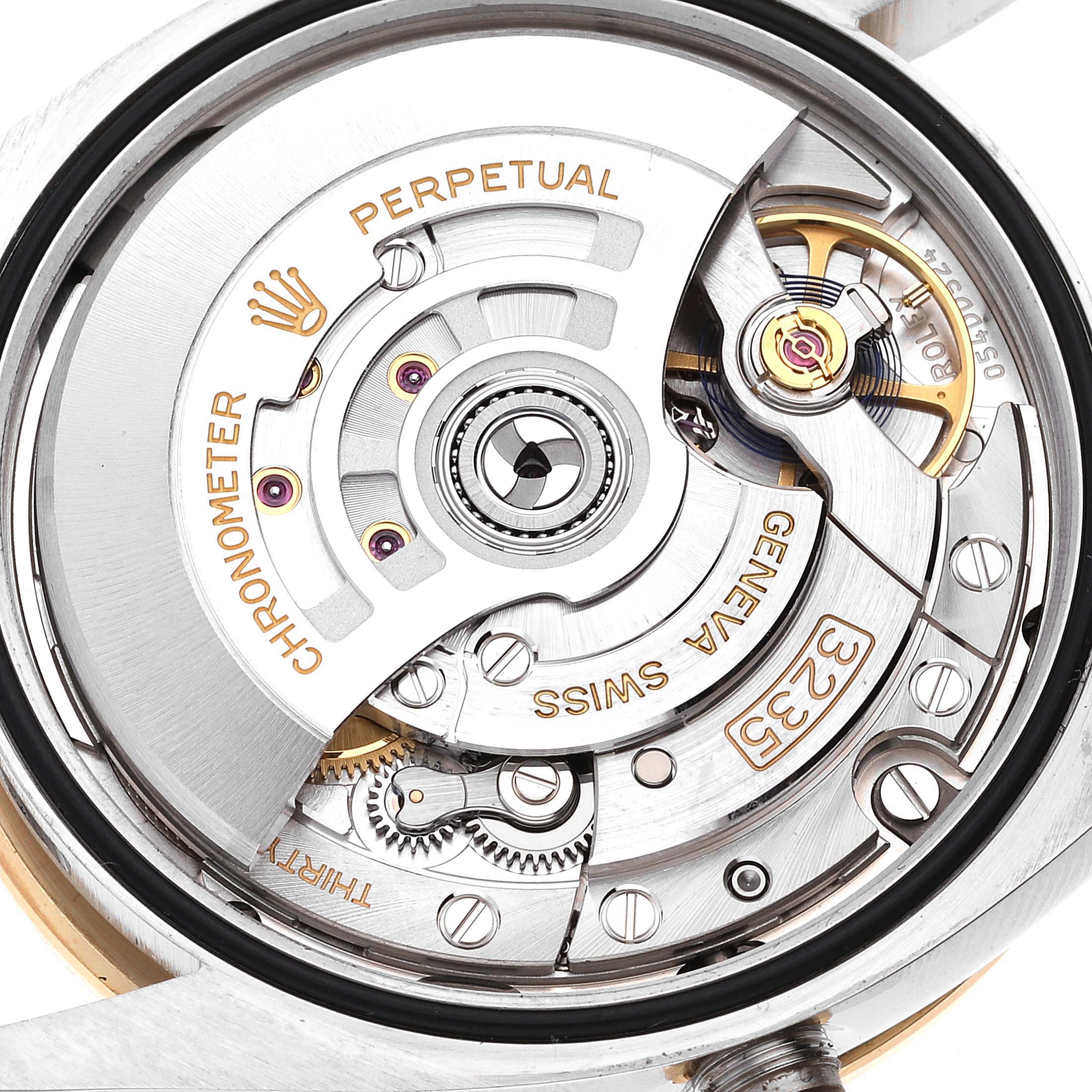 The image shows the intricate movement mechanism of a Rolex Datejust 126283 Men's Steel and Gold (two tone) Grey Dial 126283 Men's Steel and Gold (two tone) Grey Dial watch.