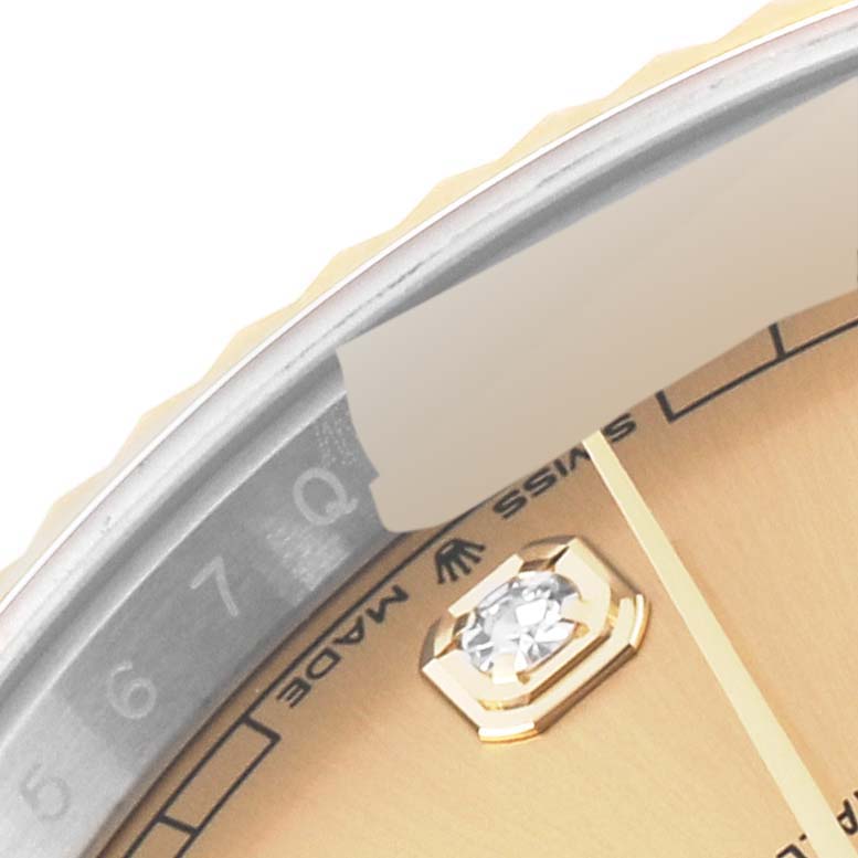This close-up image of the Rolex Datejust 41 126333 Men's Steel and Gold (two tone) Champagne Dial 126333 Men's Steel and Gold (two tone) Champagne Dial model shows a portion of the dial, bezel, and the Swiss-made insignia.