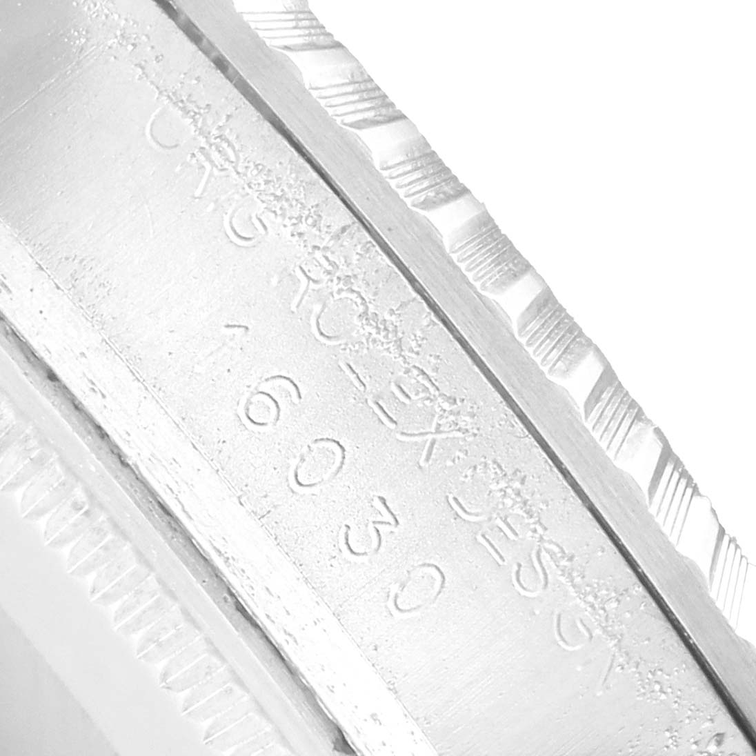 The image shows a close-up of the side engraving and bezel of the Rolex Vintage Collection 16030 Men
s Stainless Steel Silver Dial watch.