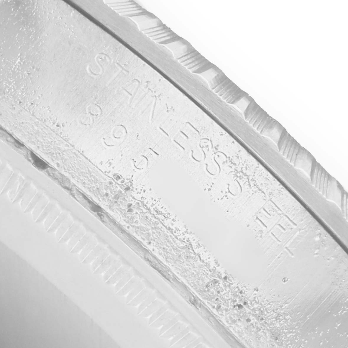 The image shows a close-up of the engraved stainless steel bezel of the Rolex Vintage Collection 16030 Men
s Stainless Steel Silver Dial watch.