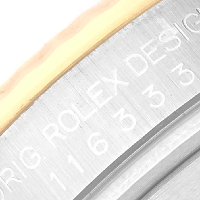 This close-up image shows the inner bezel of a Rolex Datejust 41 116333 Men's Steel and Gold (two tone) Black Dial 116333 Men's Steel and Gold (two tone) Black Dial watch displaying the model number and brand name engraving.