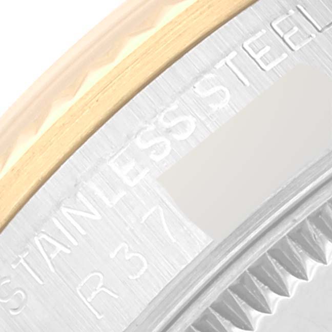 The image shows a close-up of the side of the bezel and the stainless steel inscription on a Mid-Size Rolex watch.