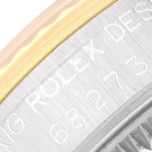 The image shows a close-up of the engraved case back edges of a Mid-Size Rolex watch.