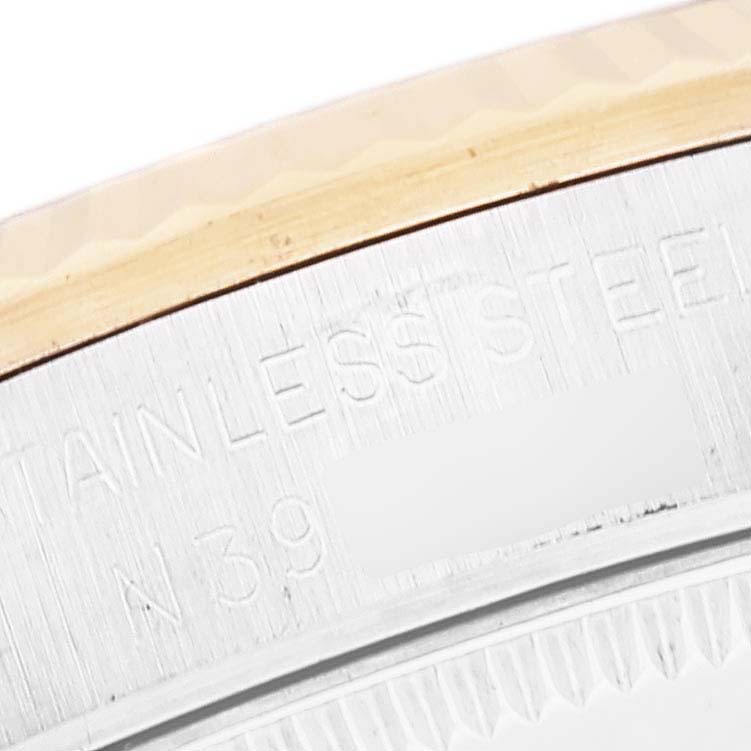 The image shows a close-up of the side engraving on a Rolex Mid-Size 68273 Women
s Steel and Gold (two tone) White Dial 68273 Women
s Steel and Gold (two tone) White Dial watch.
