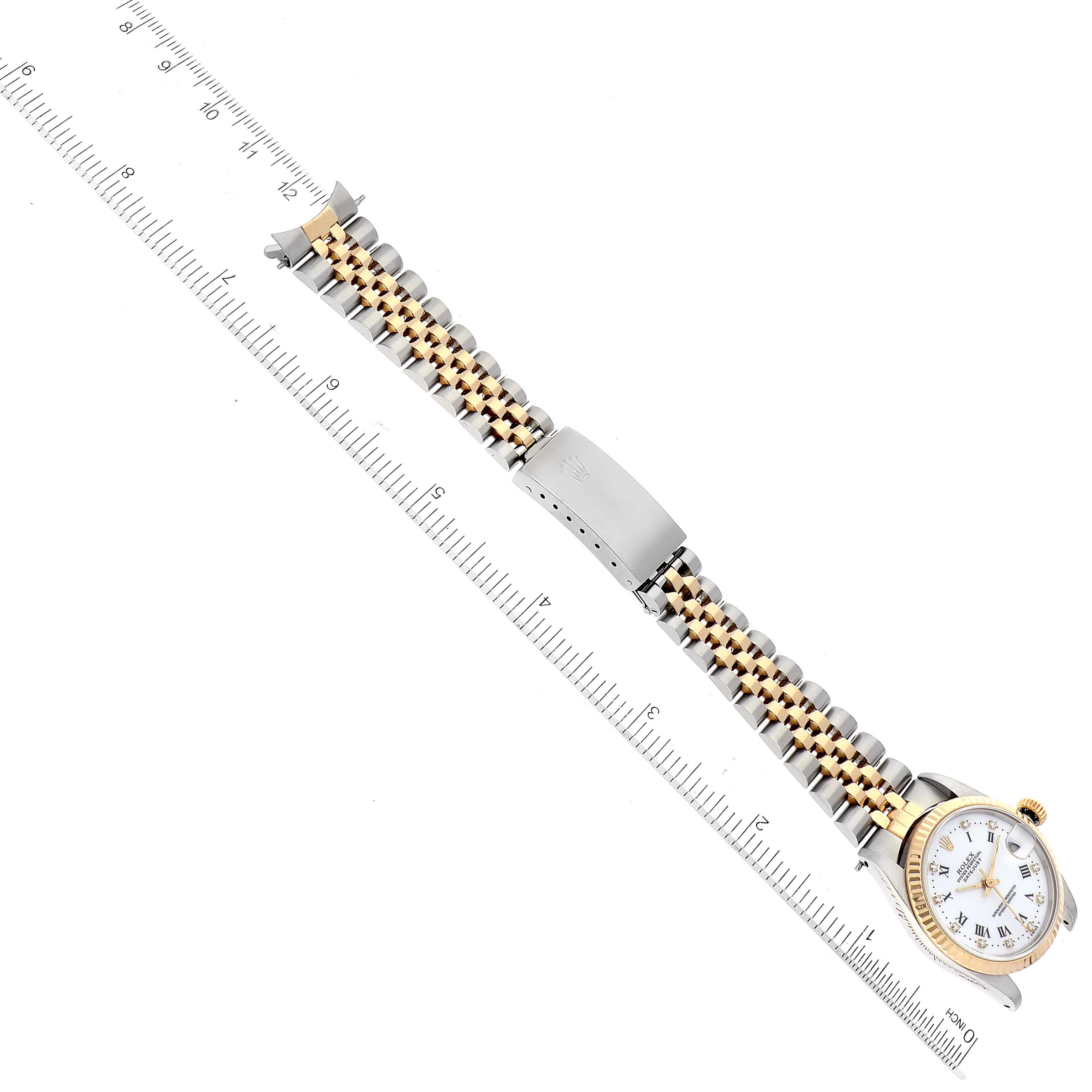 The image shows a Rolex Mid-Size 68273 Women
s Steel and Gold (two tone) White Dial 68273 Women
s Steel and Gold (two tone) White Dial model watch laid flat next to a ruler, displaying the face, bezel, and full bracelet.