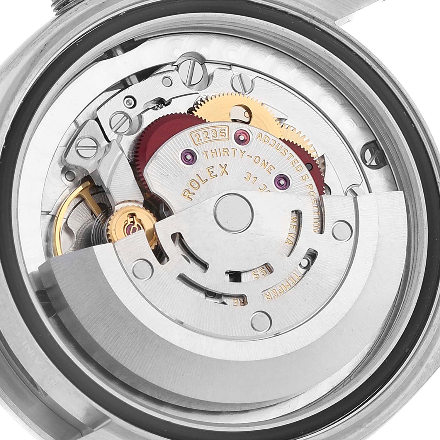 The image shows a close-up view of the interior movement mechanism of a Mid-Size Rolex watch, highlighting gears and components.