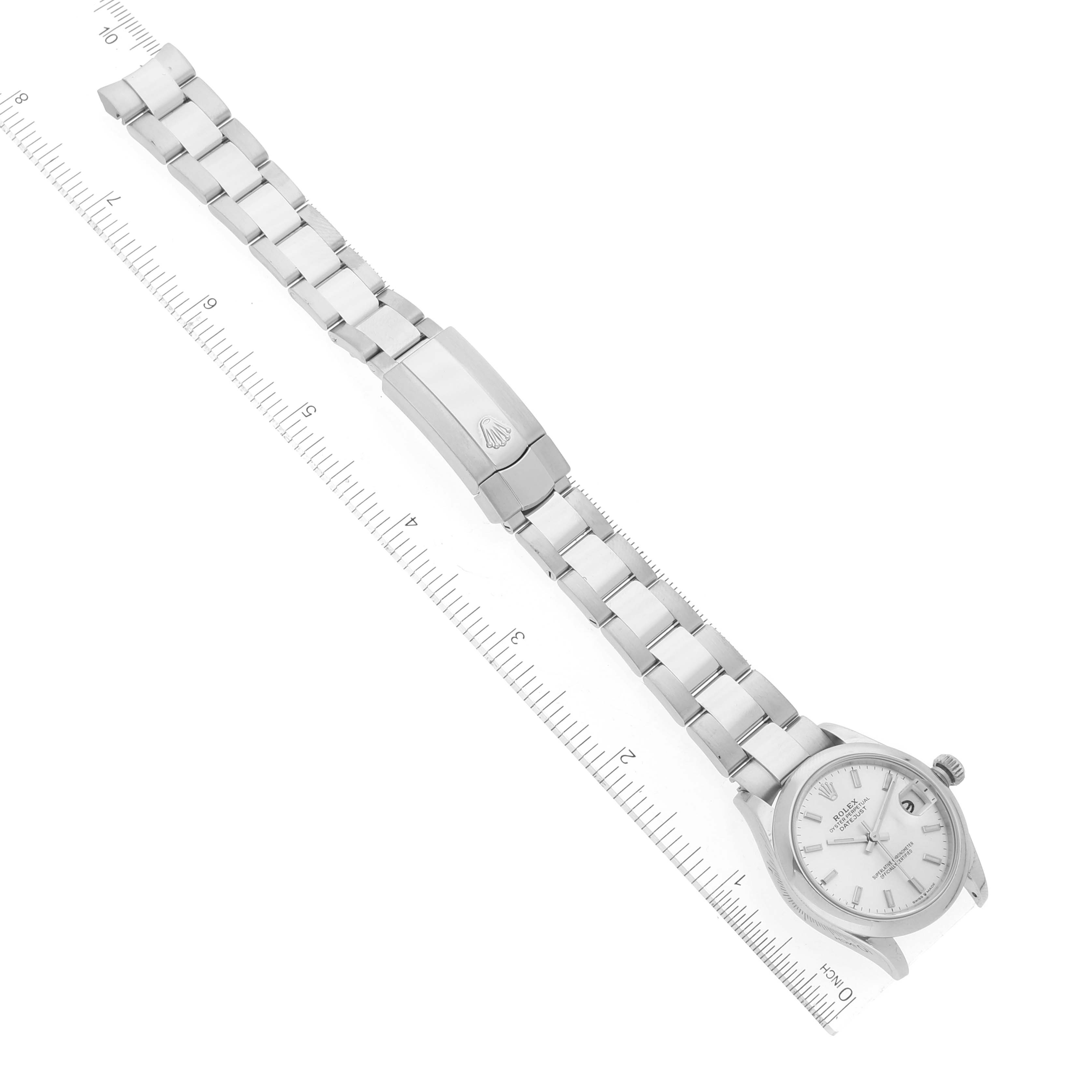 The image shows a top-down view of a Rolex Mid-Size 278240 Women's Stainless Steel Silver Dial 278240 Women's Stainless Steel Silver Dial watch with its metal bracelet fully extended alongside a ruler.