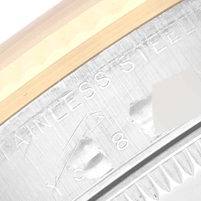 The image shows a close-up of the stainless steel part and engraved details of a Mid-Size Rolex watch.